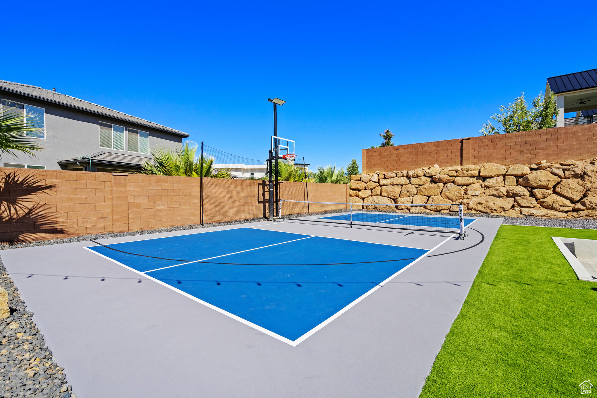 View of basketball court with a lawn and tennis court