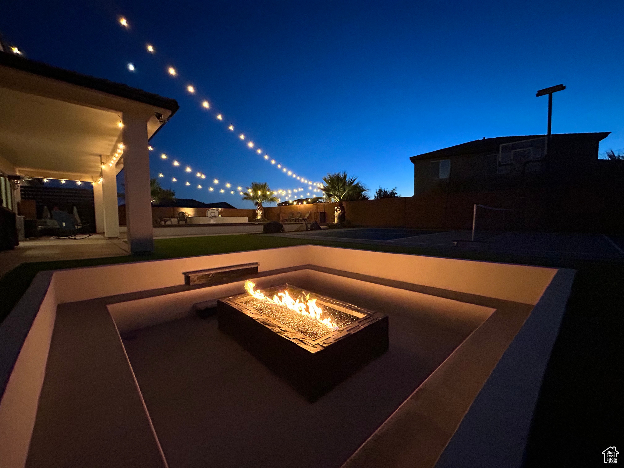 View of patio with an outdoor fire pit