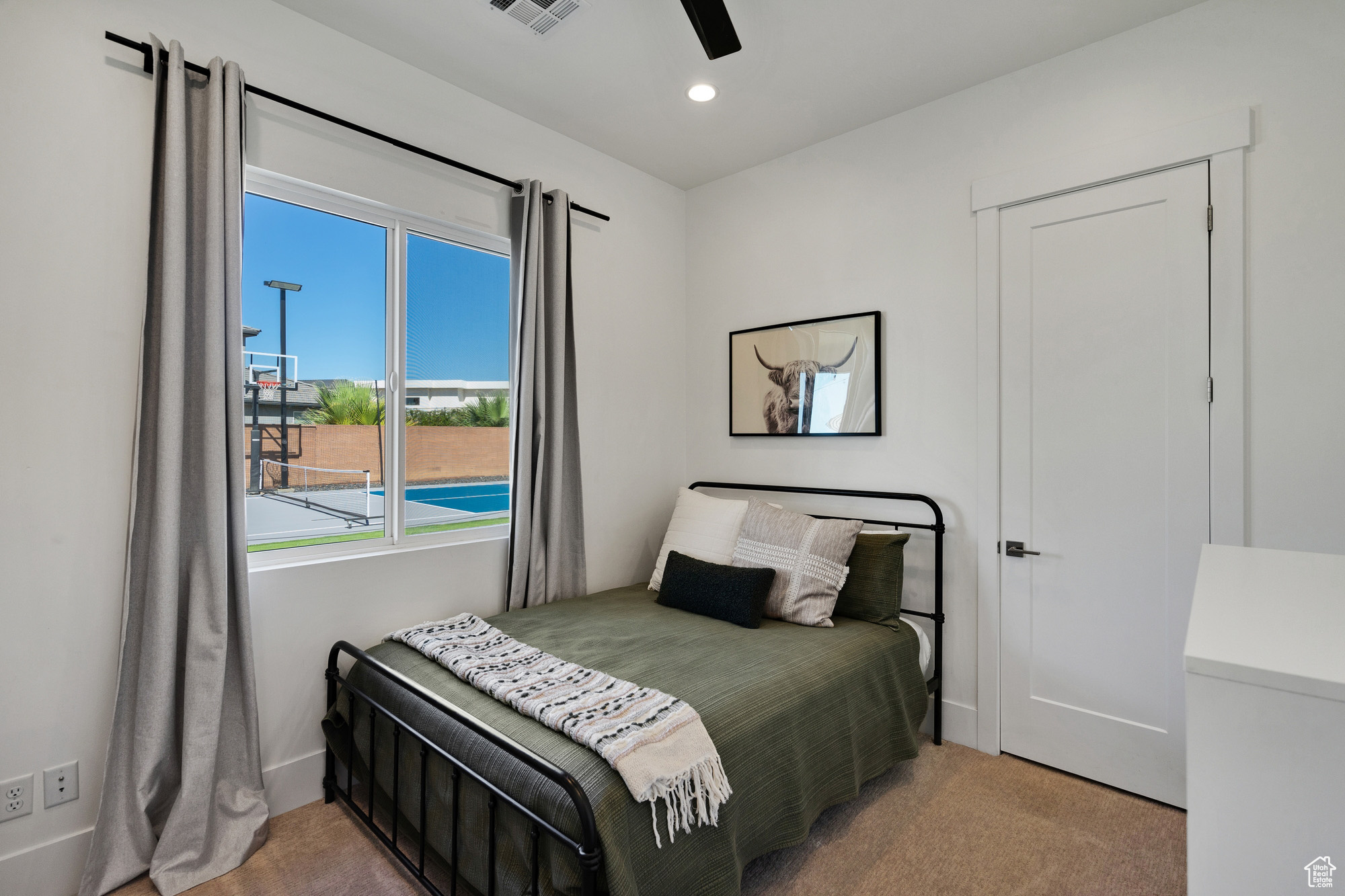 Carpeted bedroom with ceiling fan