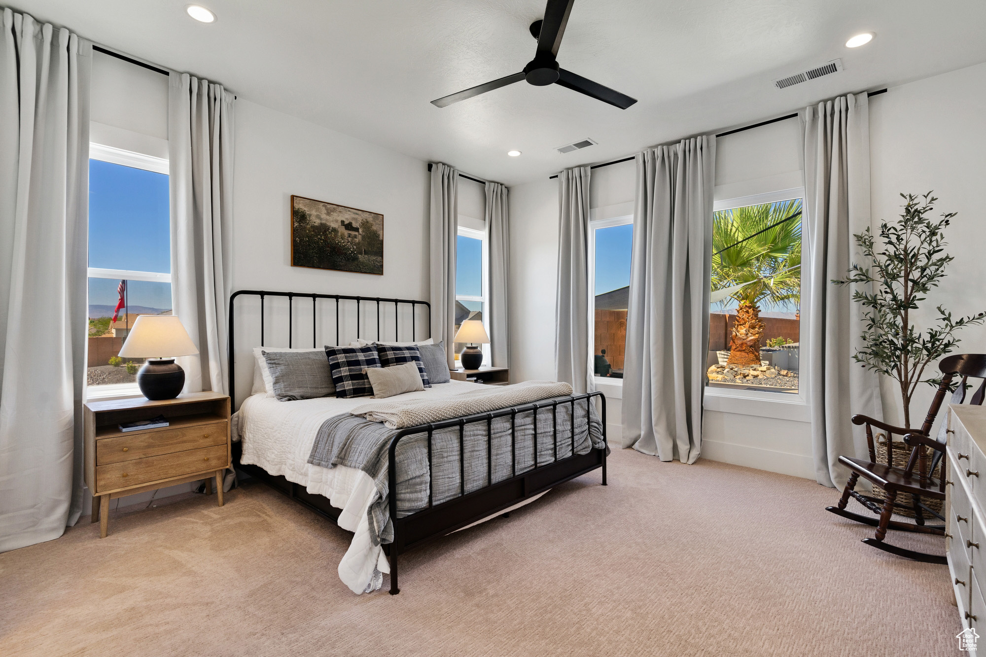 Carpeted bedroom featuring ceiling fan