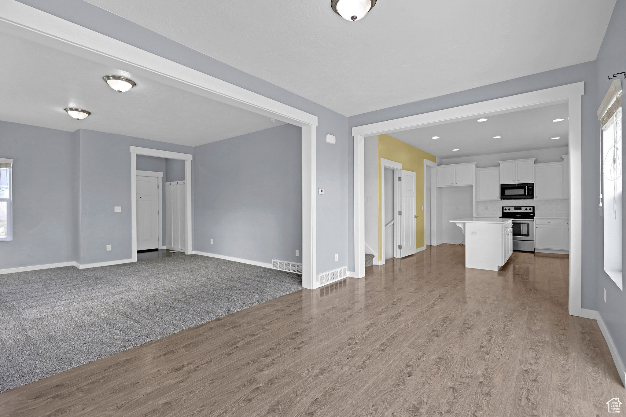 Unfurnished living room featuring light wood-type flooring