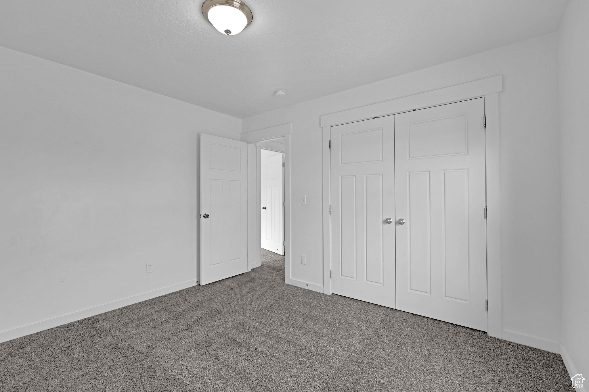 Unfurnished bedroom featuring a closet and carpet floors