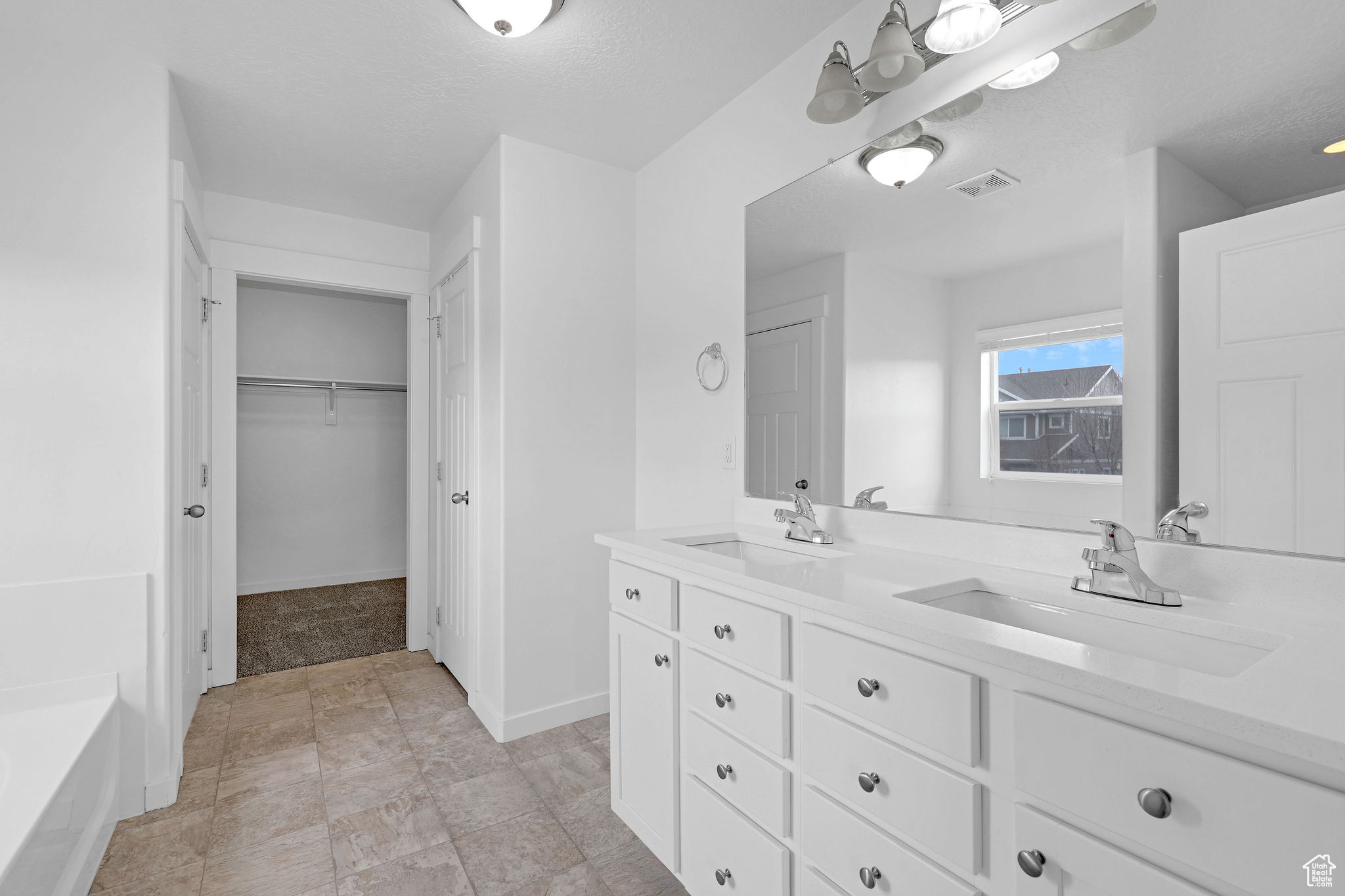 Bathroom featuring vanity and a textured ceiling