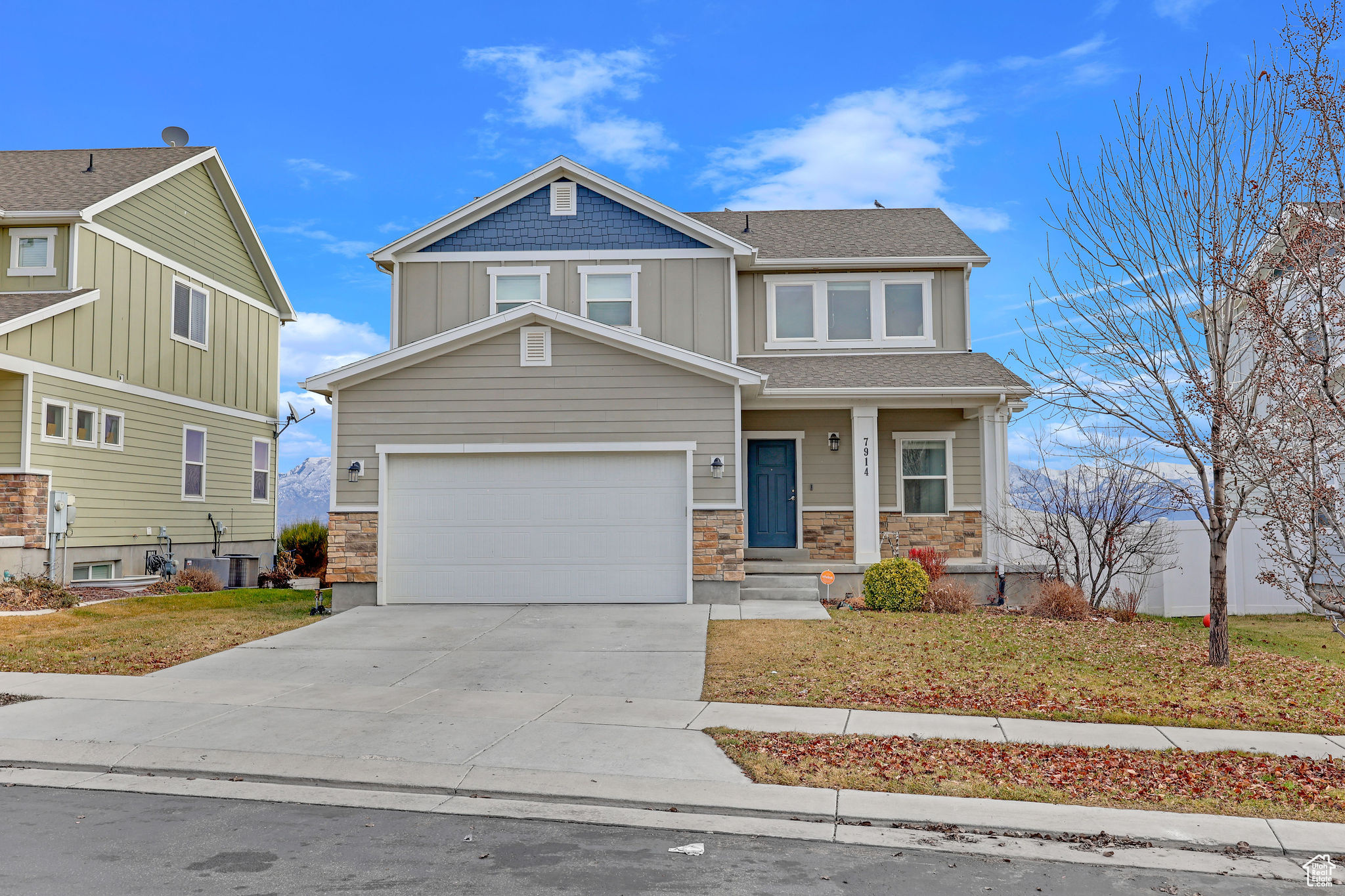 Craftsman inspired home with a garage and central AC