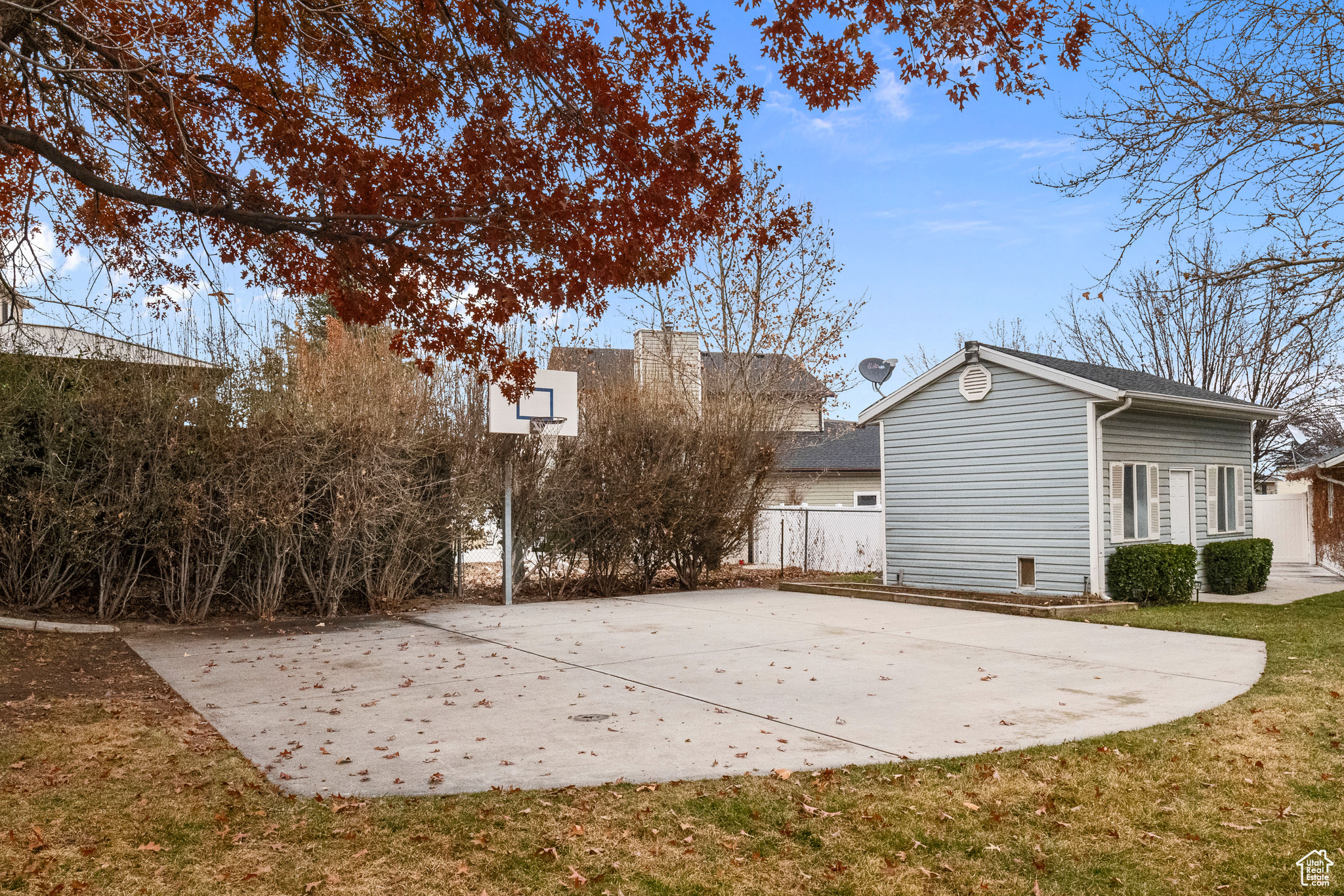 View of basketball court with a yard