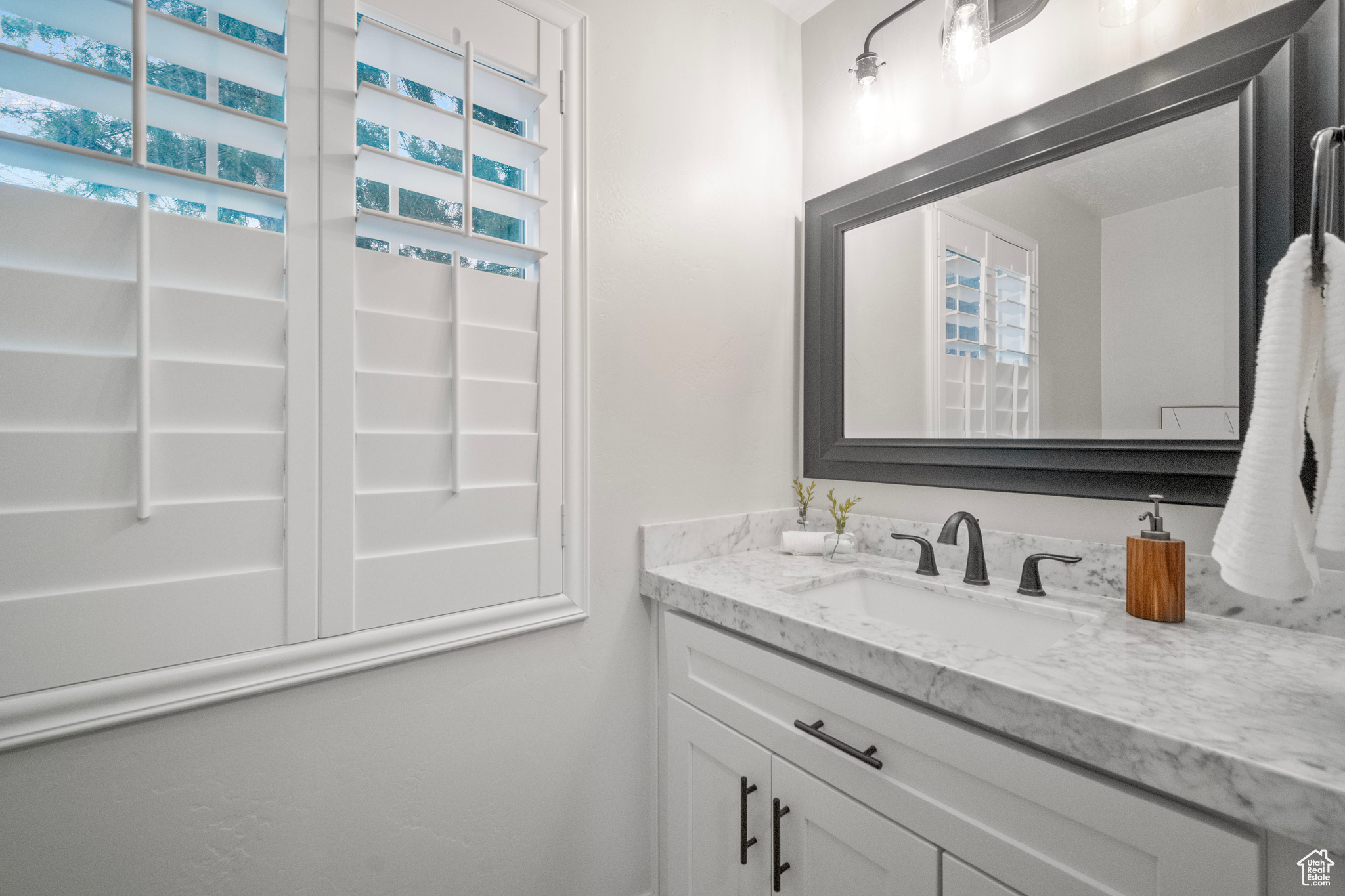 Bathroom with a wealth of natural light and vanity