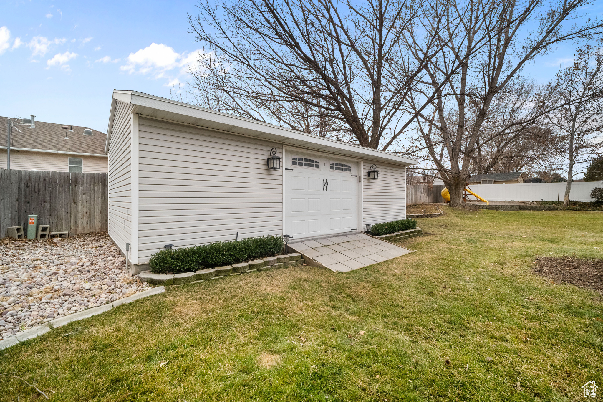 View of outdoor structure with a lawn and a garage