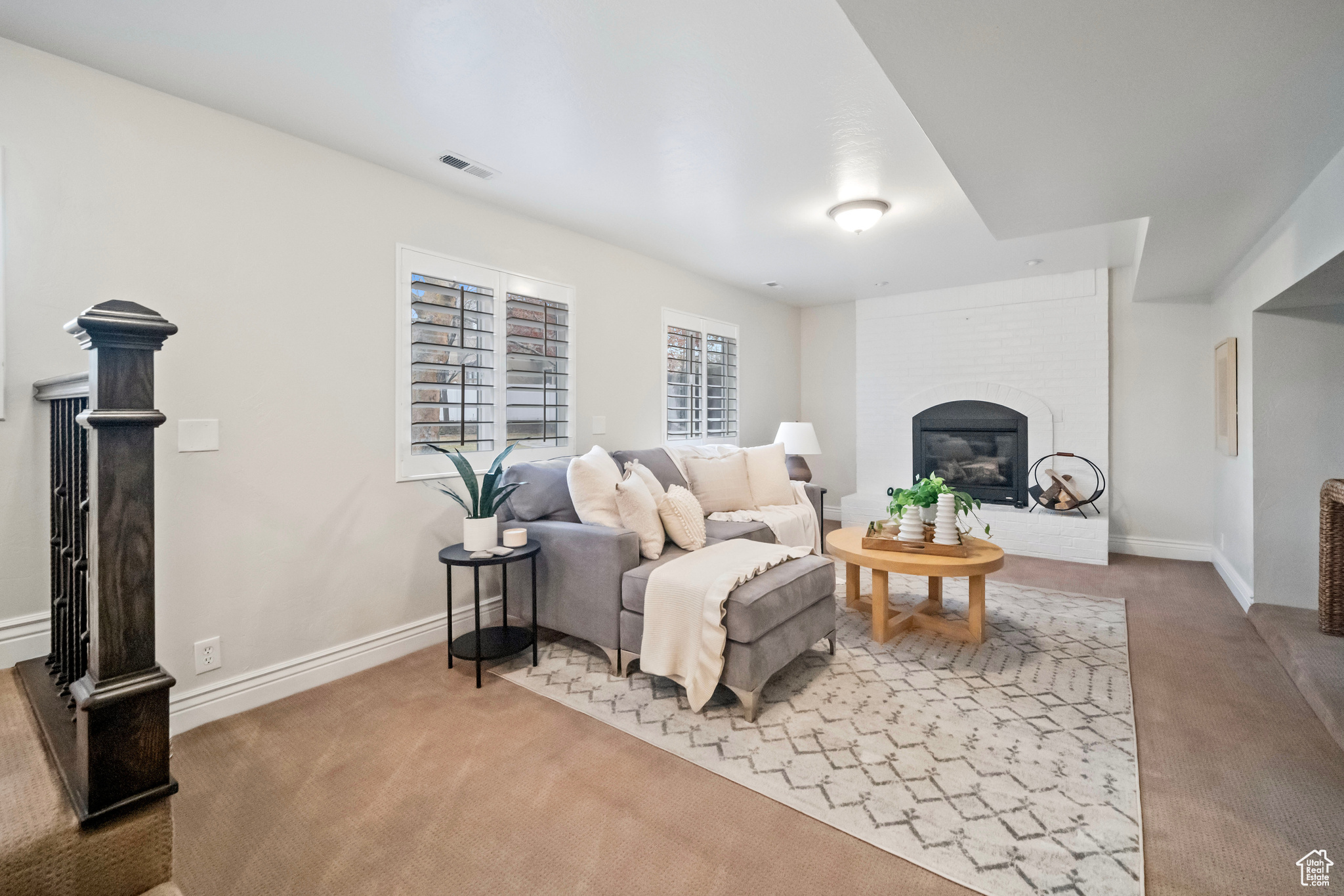 Living room with a fireplace and carpet