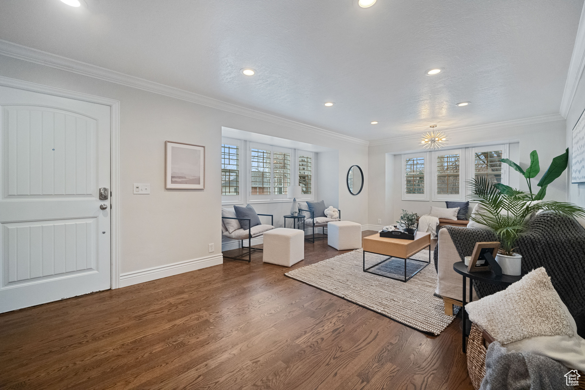 Living room featuring plenty of natural light and ornamental molding