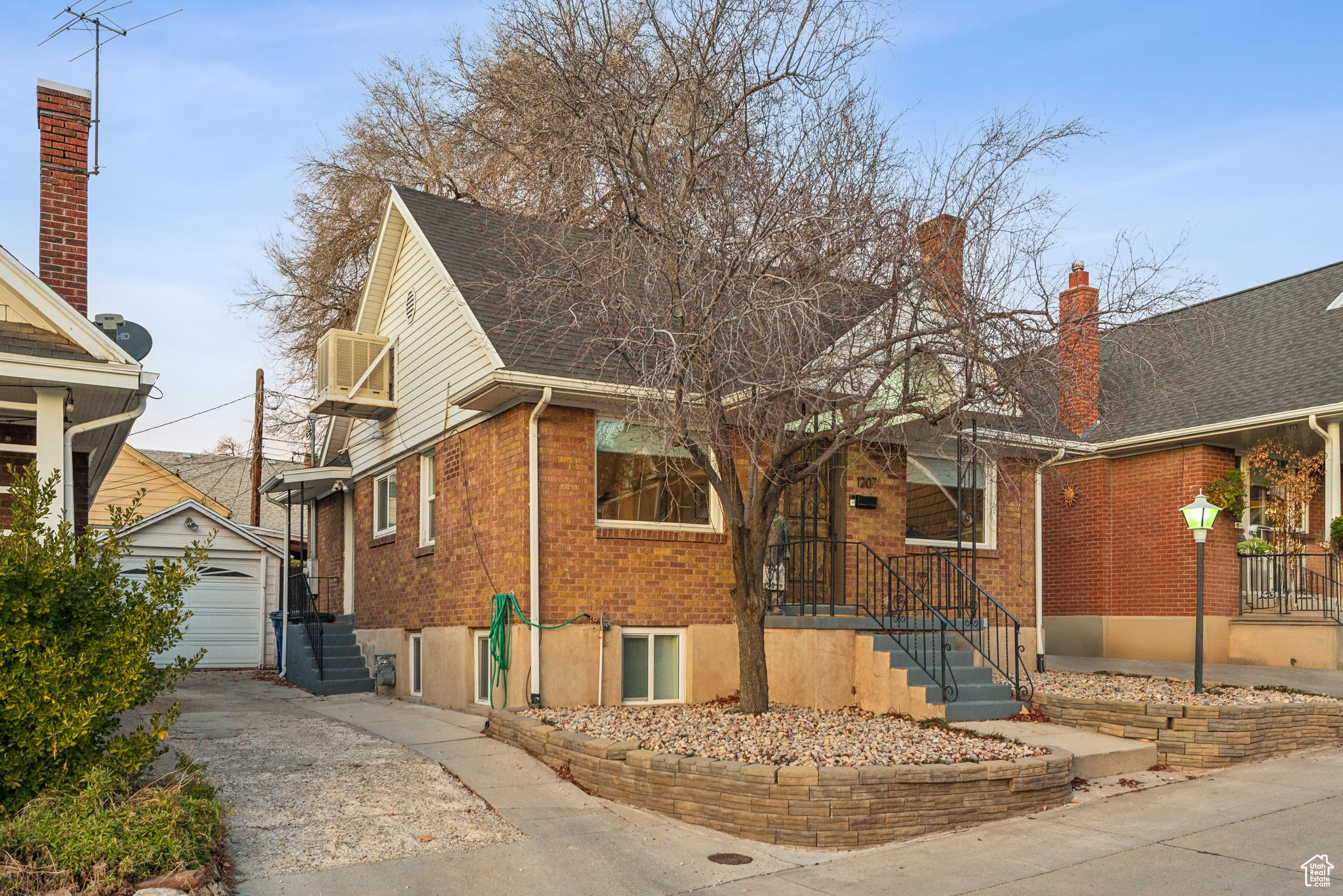 View of front of property with an outbuilding and a garage