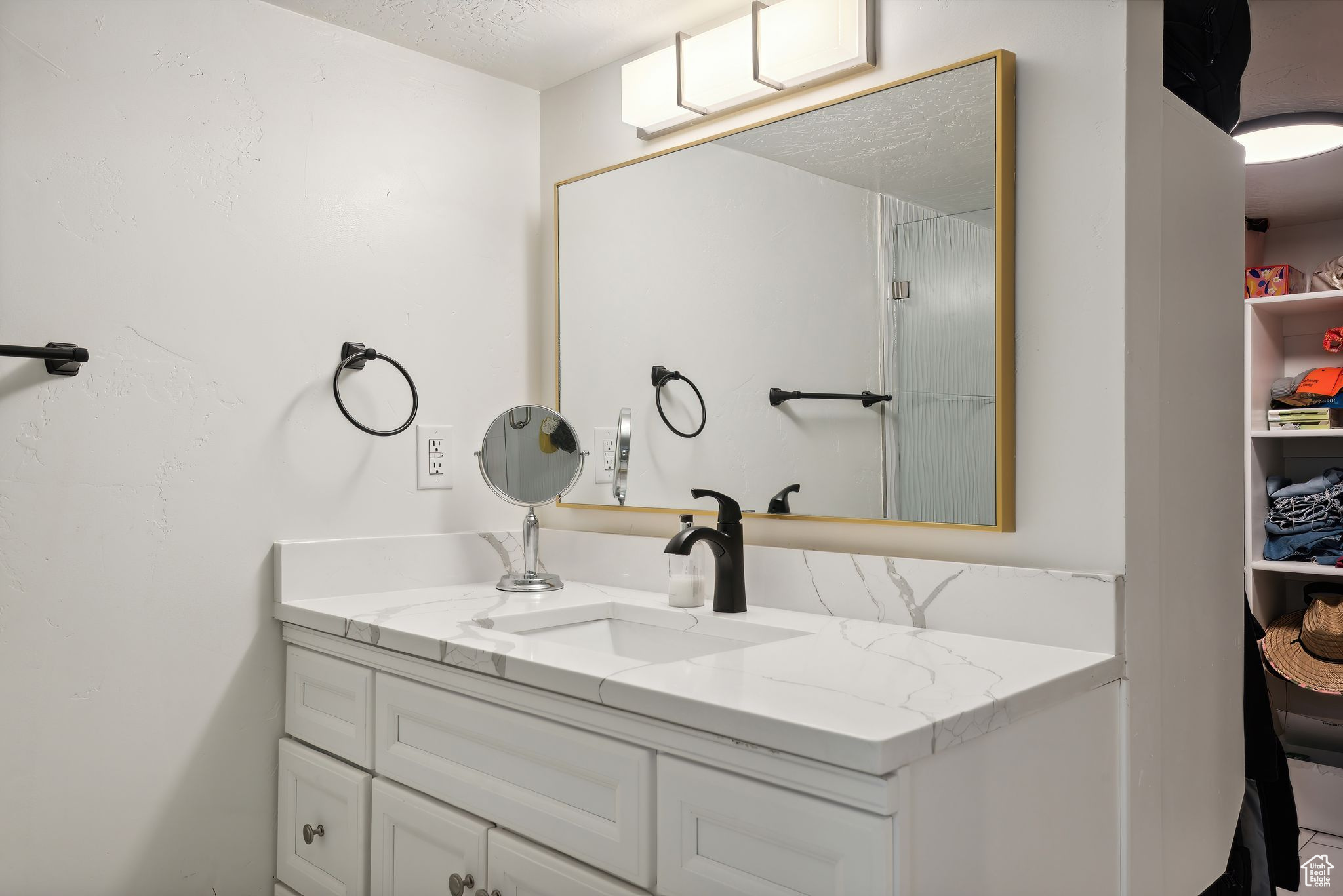 Bathroom featuring vanity and a textured ceiling