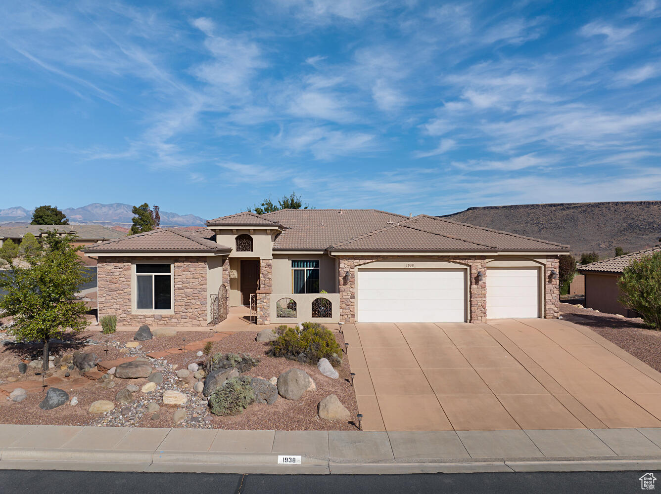 View of front of home featuring a mountain view and a garage