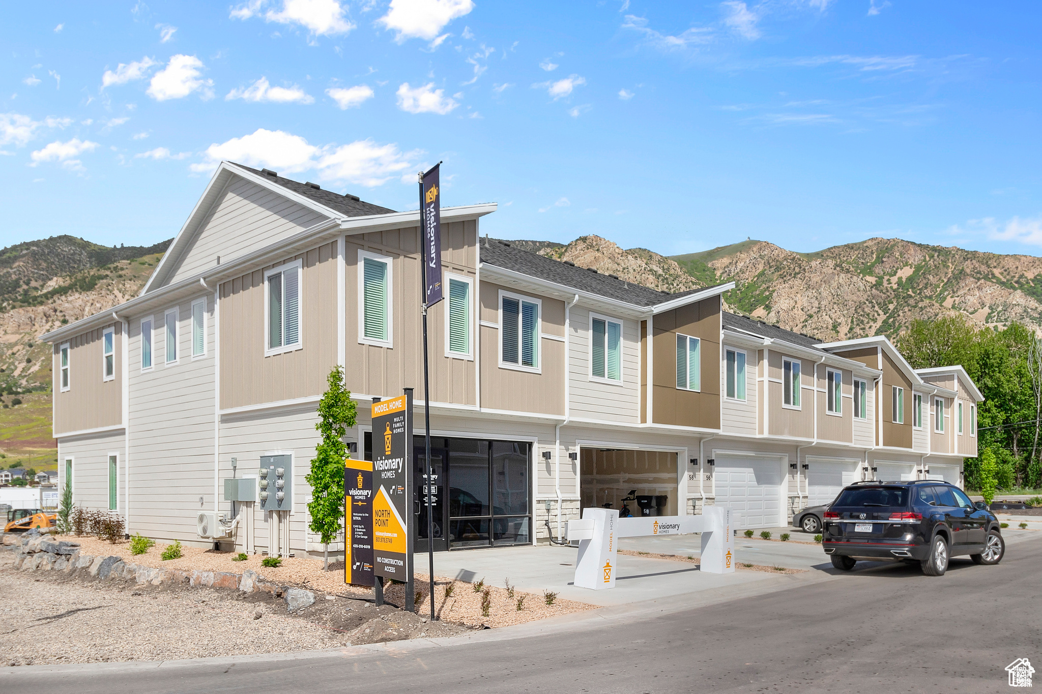 View of front facade with a mountain view and a garage