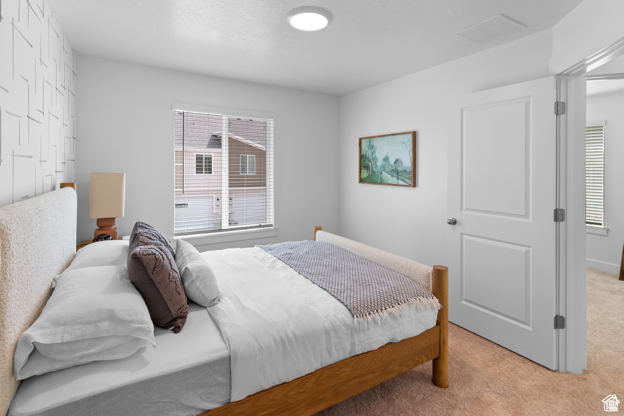 Carpeted bedroom featuring a closet