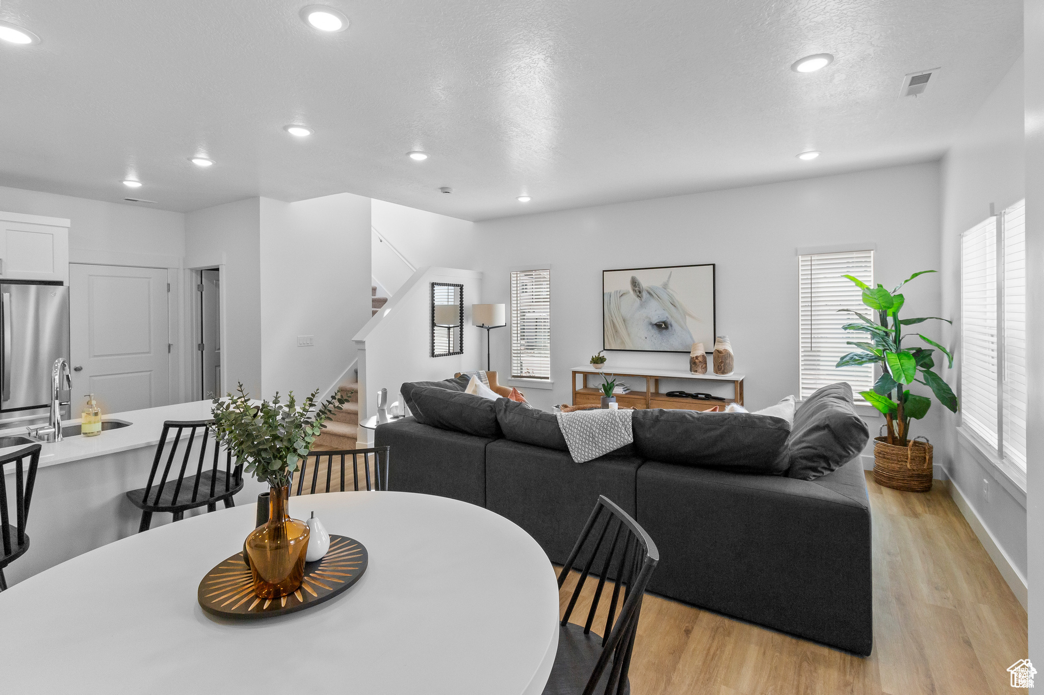 Dining space with a wealth of natural light and light hardwood / wood-style flooring