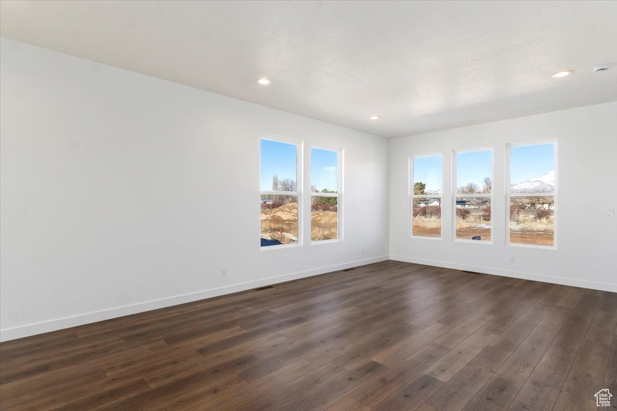 Spare room featuring dark hardwood / wood-style flooring