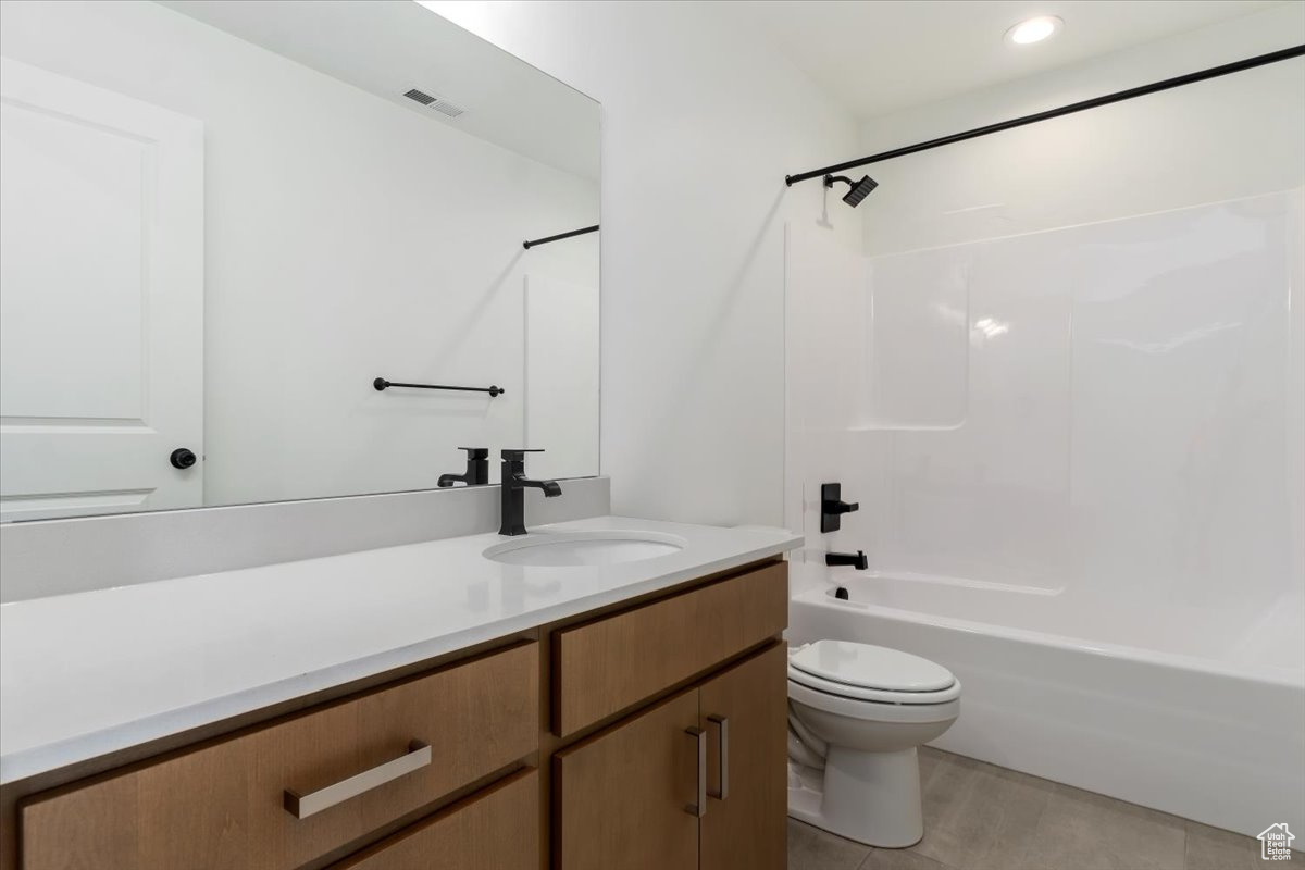 Full bathroom with hardwood / wood-style flooring, vanity, toilet, and bathtub / shower combination