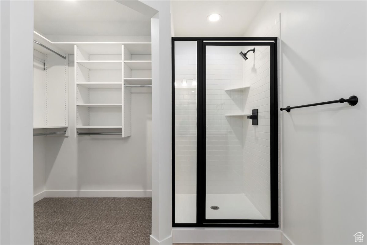 Bathroom featuring a shower with door