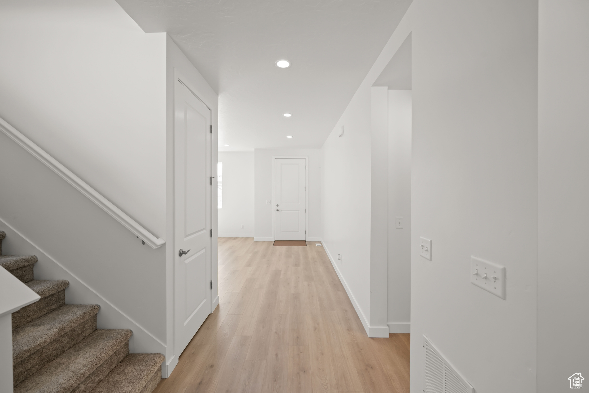 Hall with light hardwood / wood-style floors