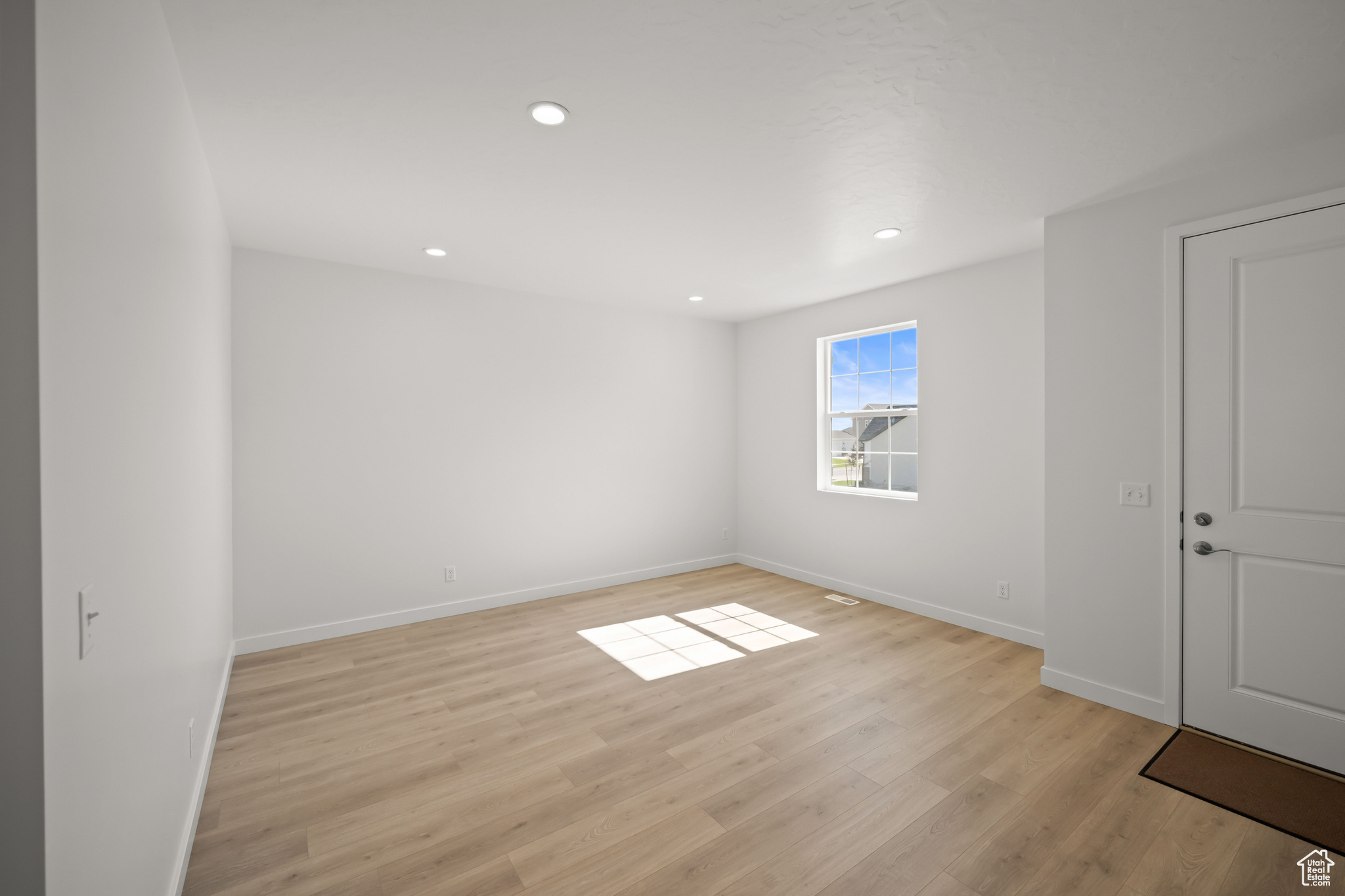 Spare room with light wood-type flooring