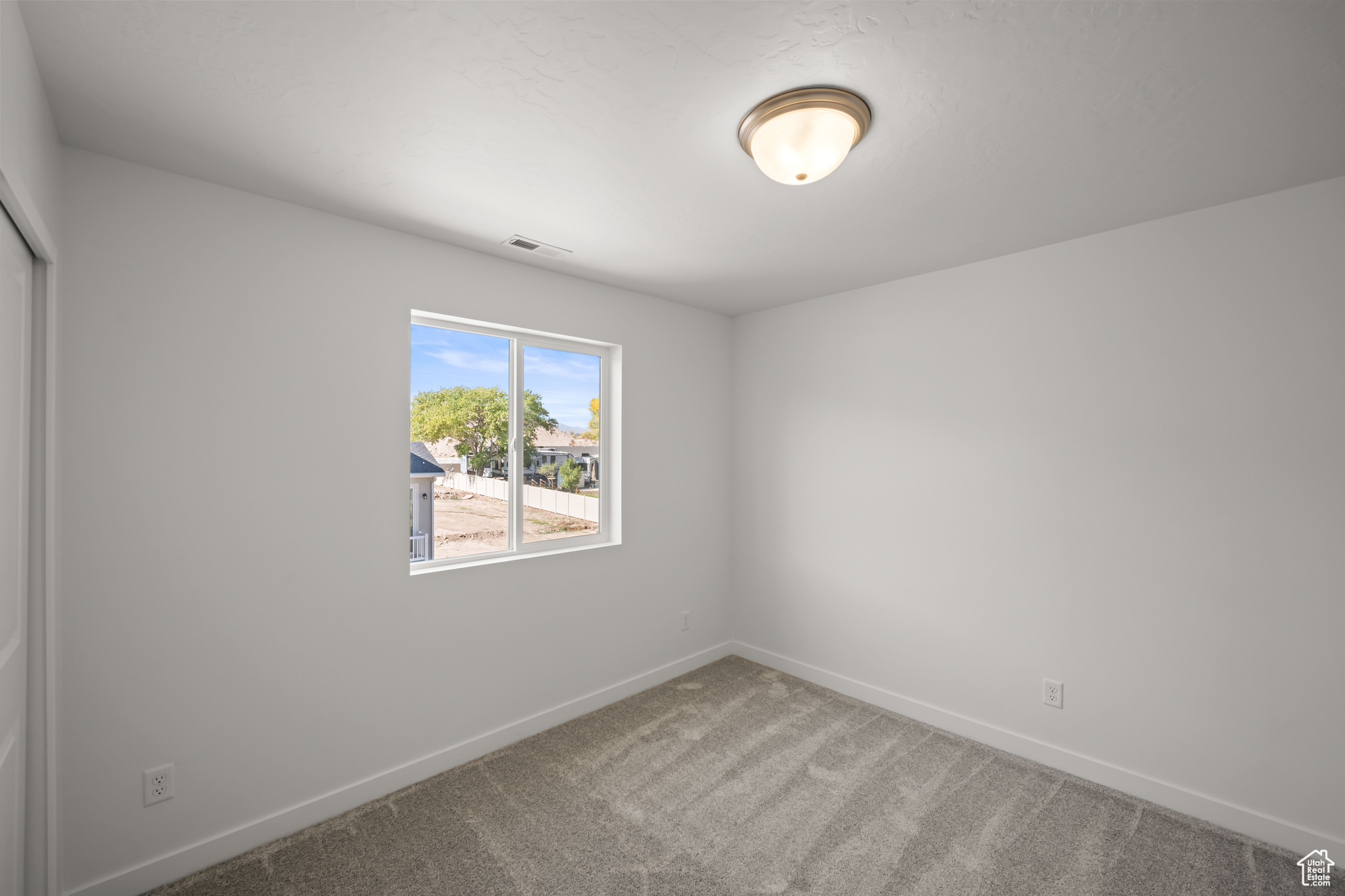 Spare room featuring carpet