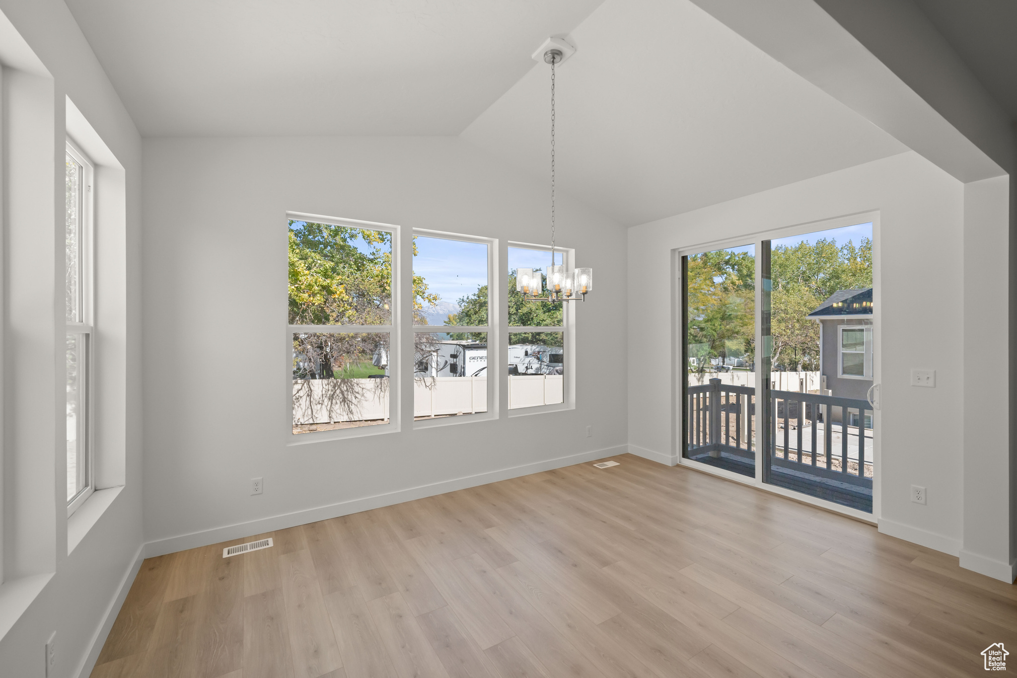 Unfurnished dining area with a notable chandelier and a wealth of natural light