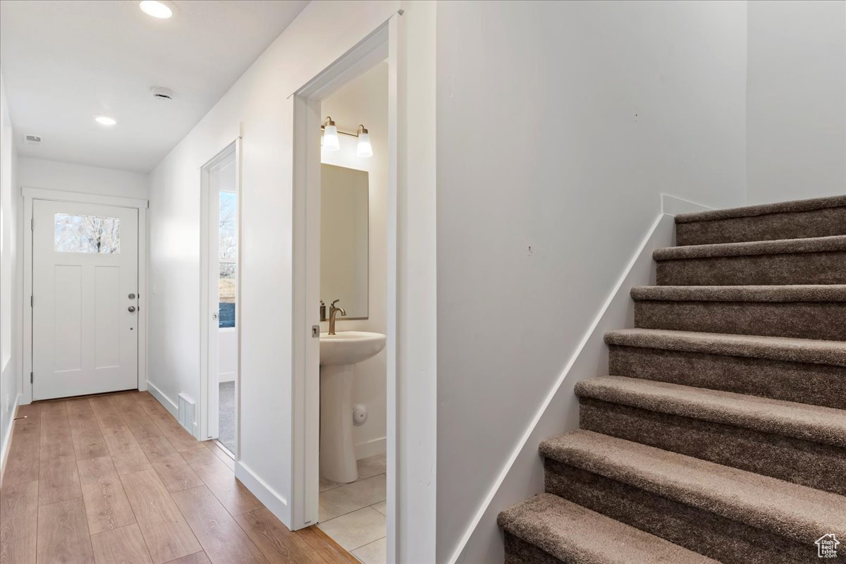 Foyer entrance with light wood-type flooring