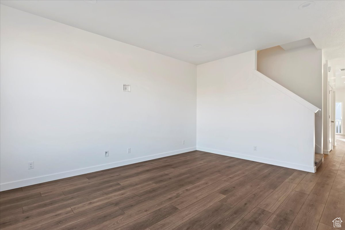 Unfurnished room with dark hardwood / wood-style flooring