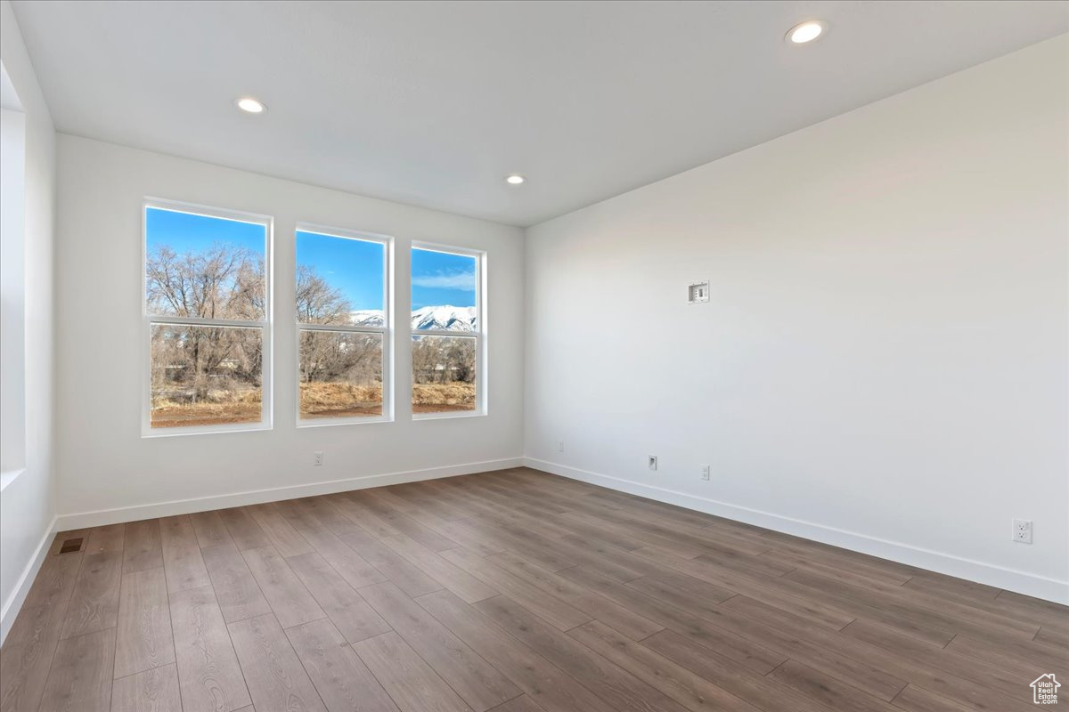 Empty room with dark wood-type flooring