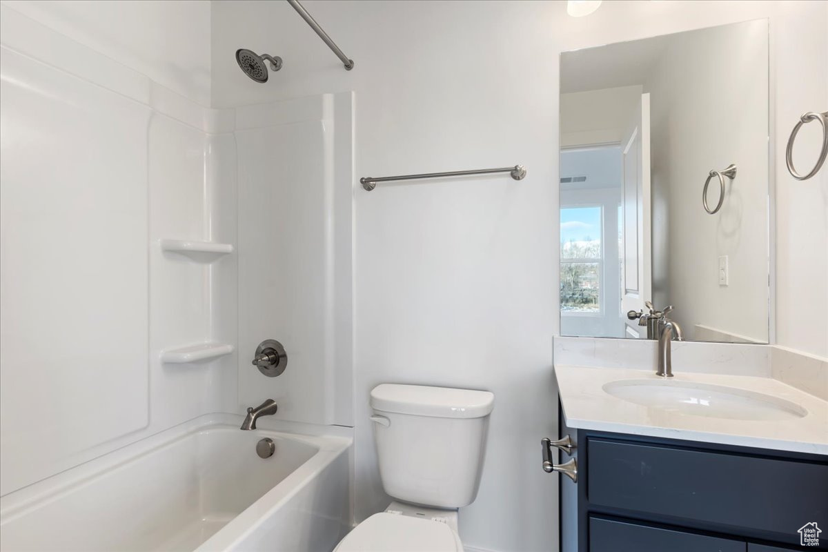 Full bathroom with vanity, toilet, and shower / washtub combination