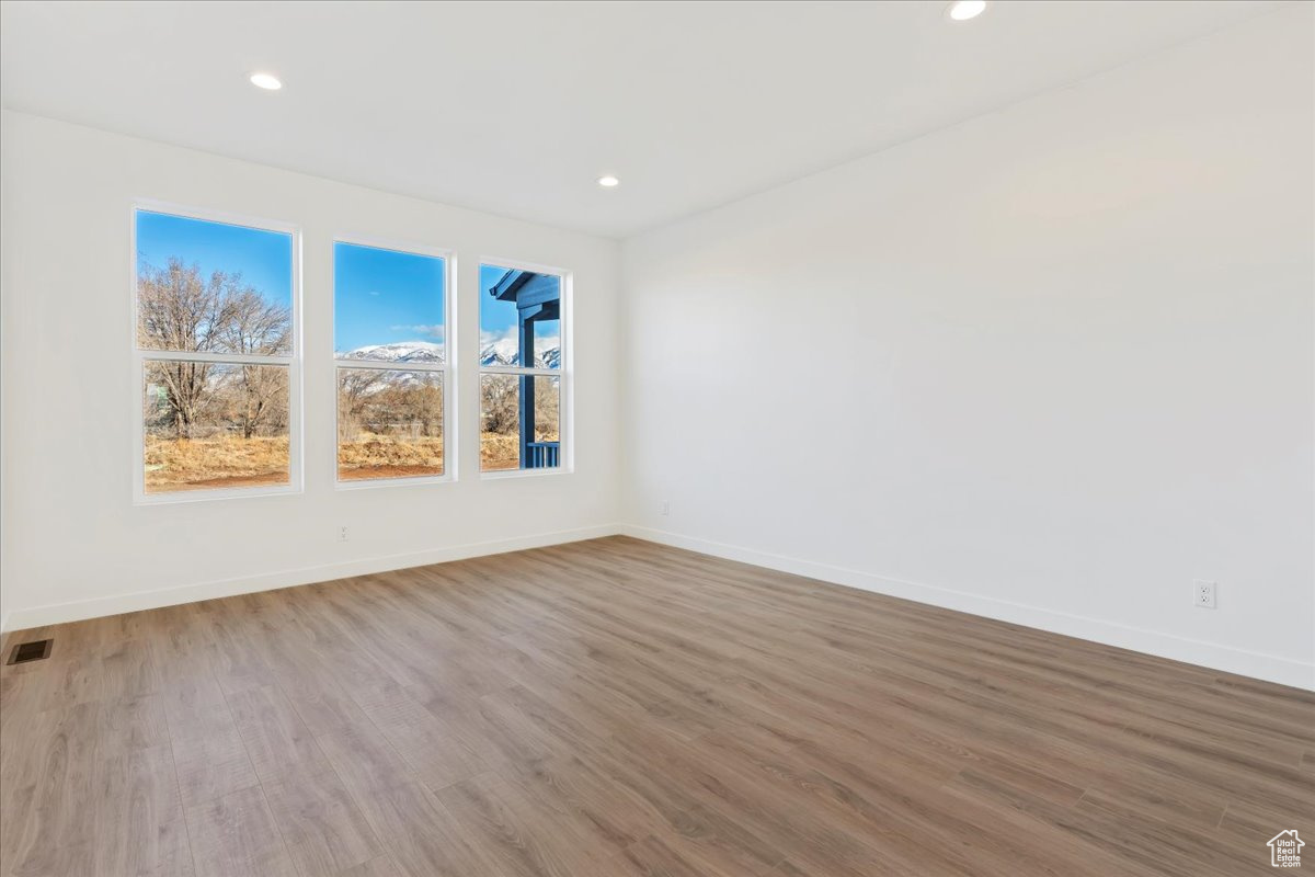 Unfurnished room featuring hardwood / wood-style floors