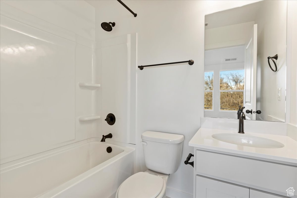 Full bathroom with vanity, toilet, and shower / bathtub combination