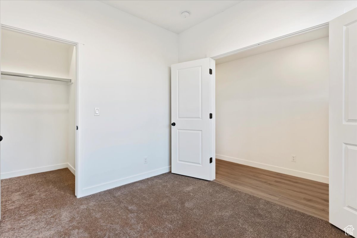 Unfurnished bedroom with carpet floors and a closet