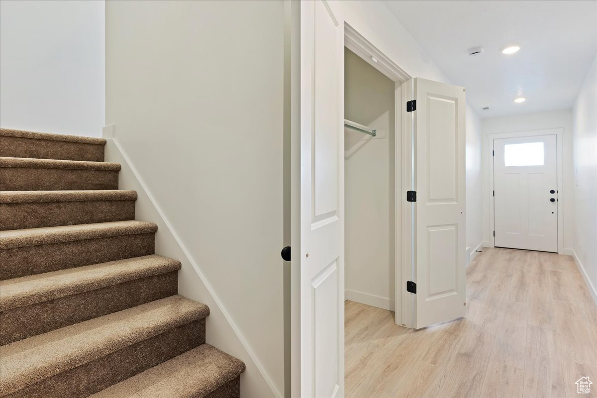 Stairway with hardwood / wood-style floors