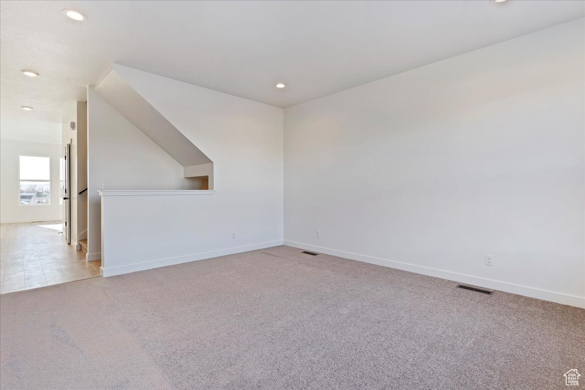 Unfurnished room with light colored carpet