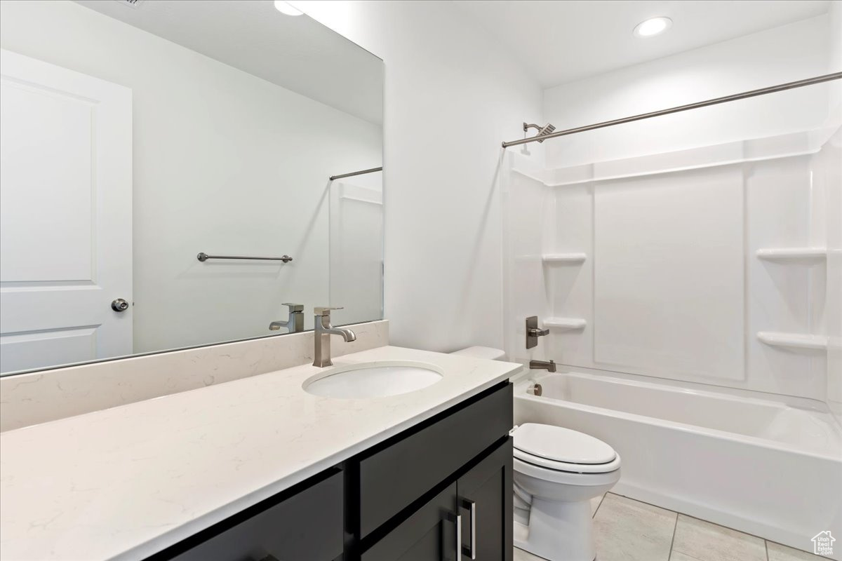 Full bathroom featuring tile patterned floors, vanity, shower / bathtub combination, and toilet