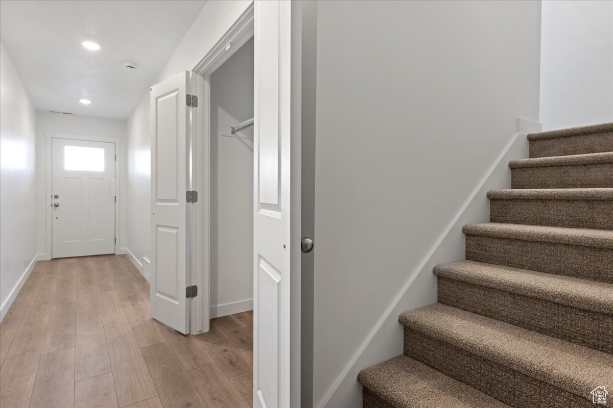 Staircase featuring wood-type flooring