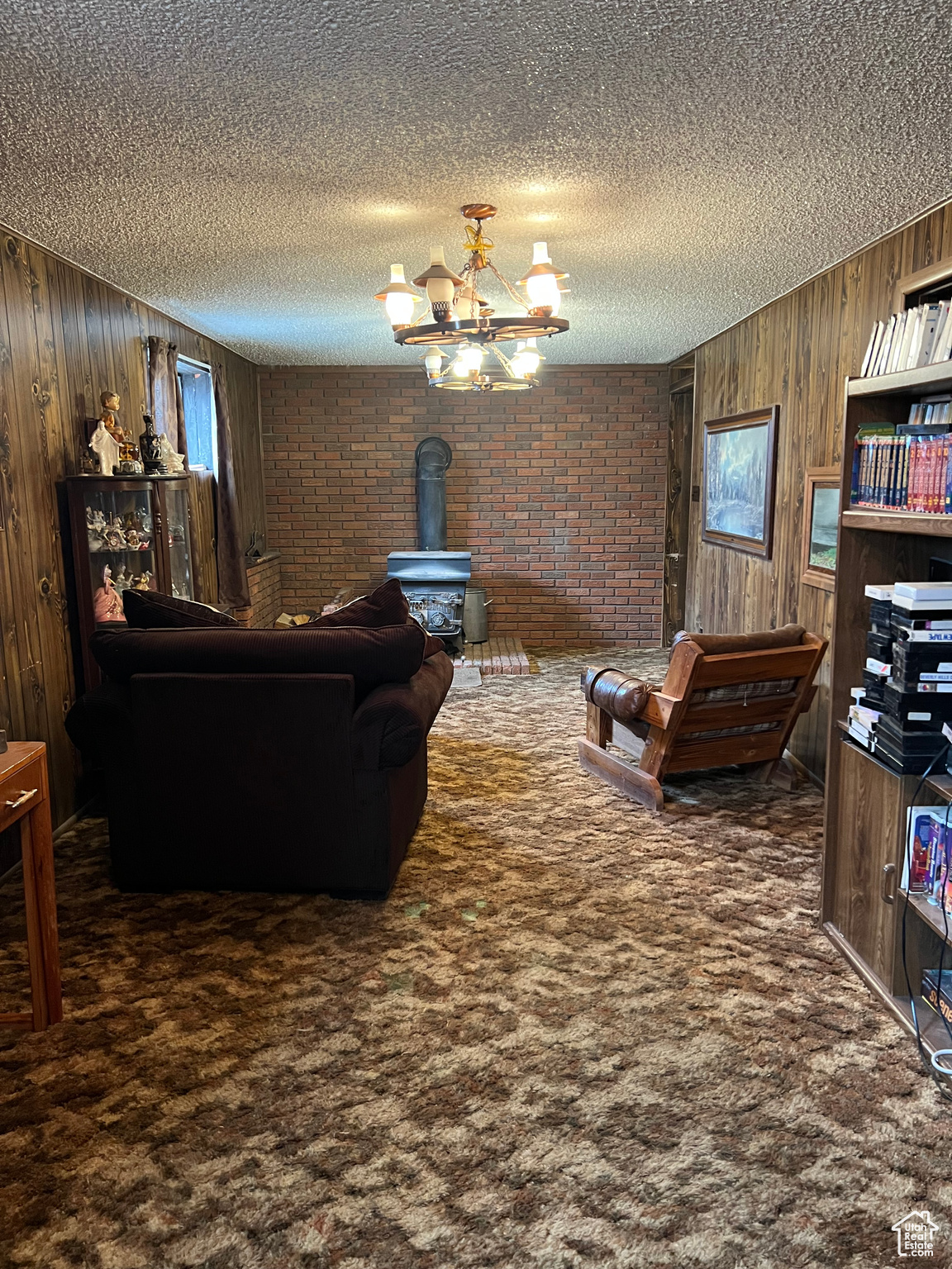 Carpeted living room featuring  a wood stove