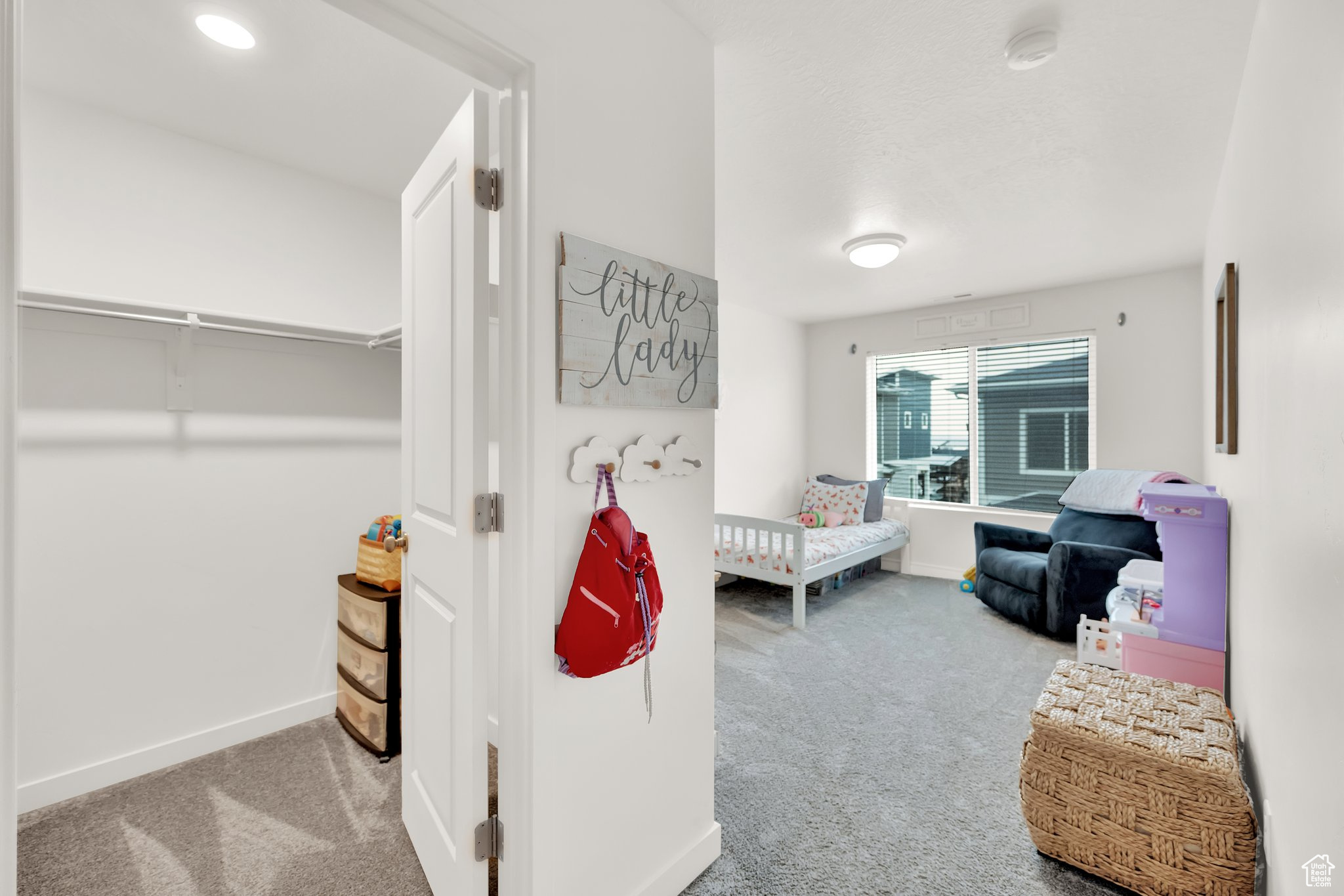 Carpeted bedroom with a nursery area