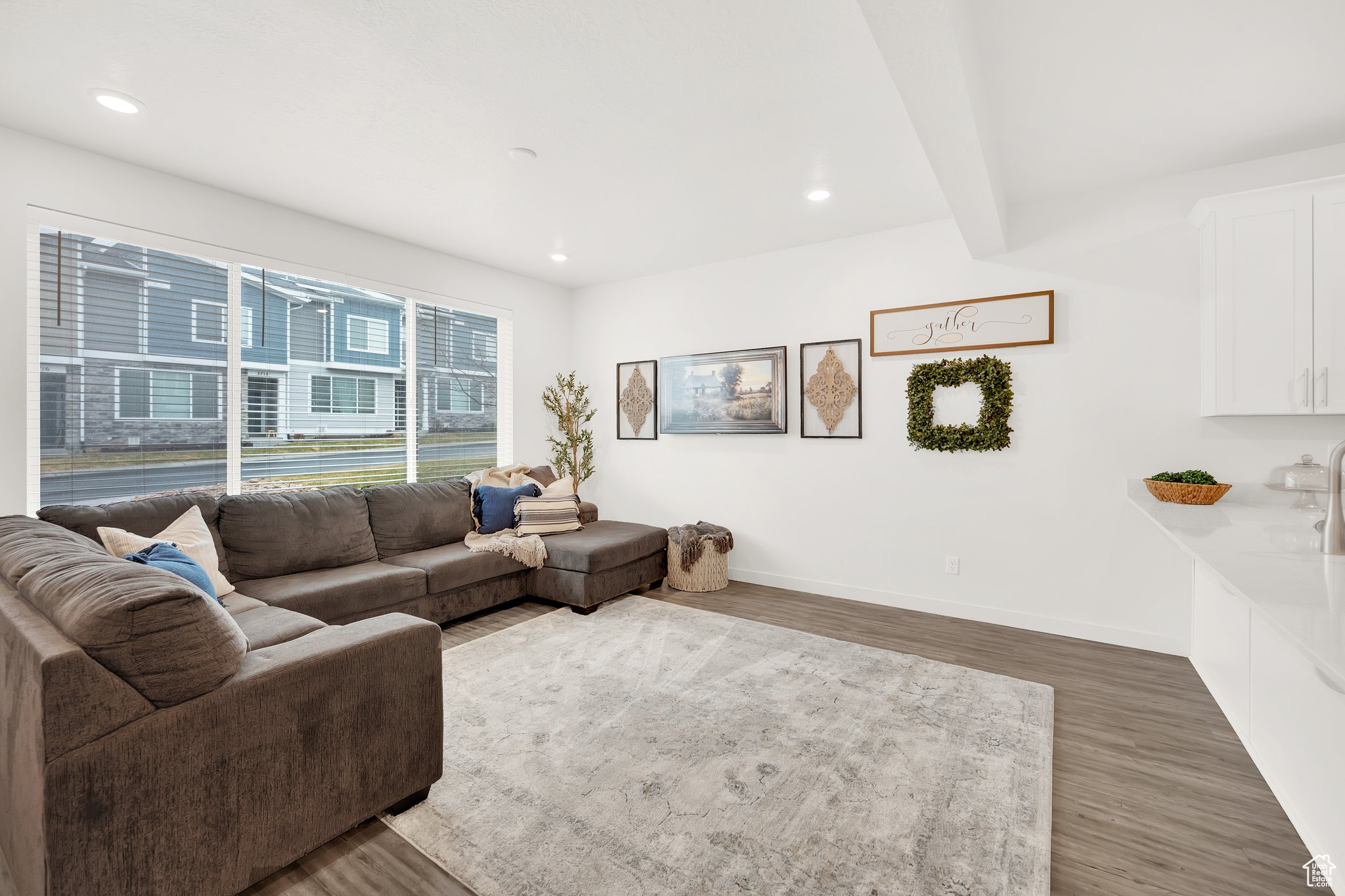 Living room featuring beam ceiling and dark hardwood / wood-style floors