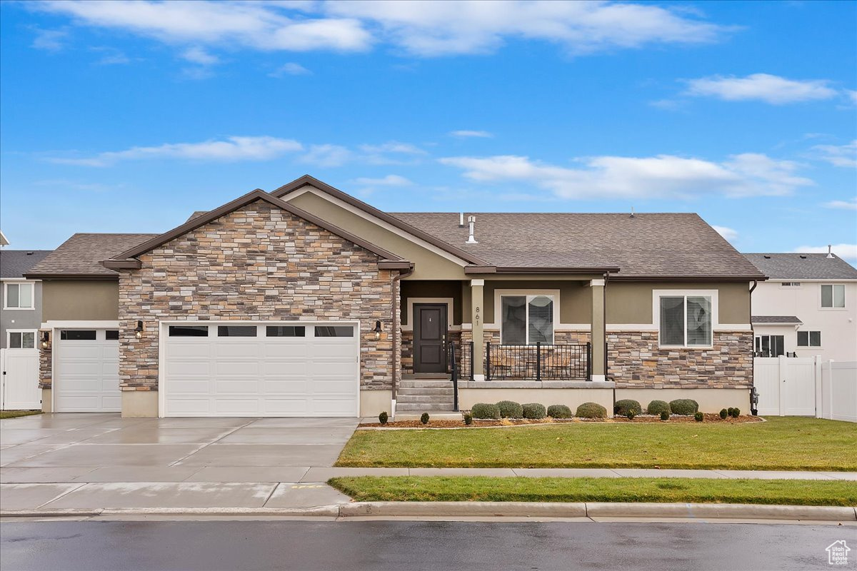 Craftsman-style house featuring a porch, a garage, and a front yard