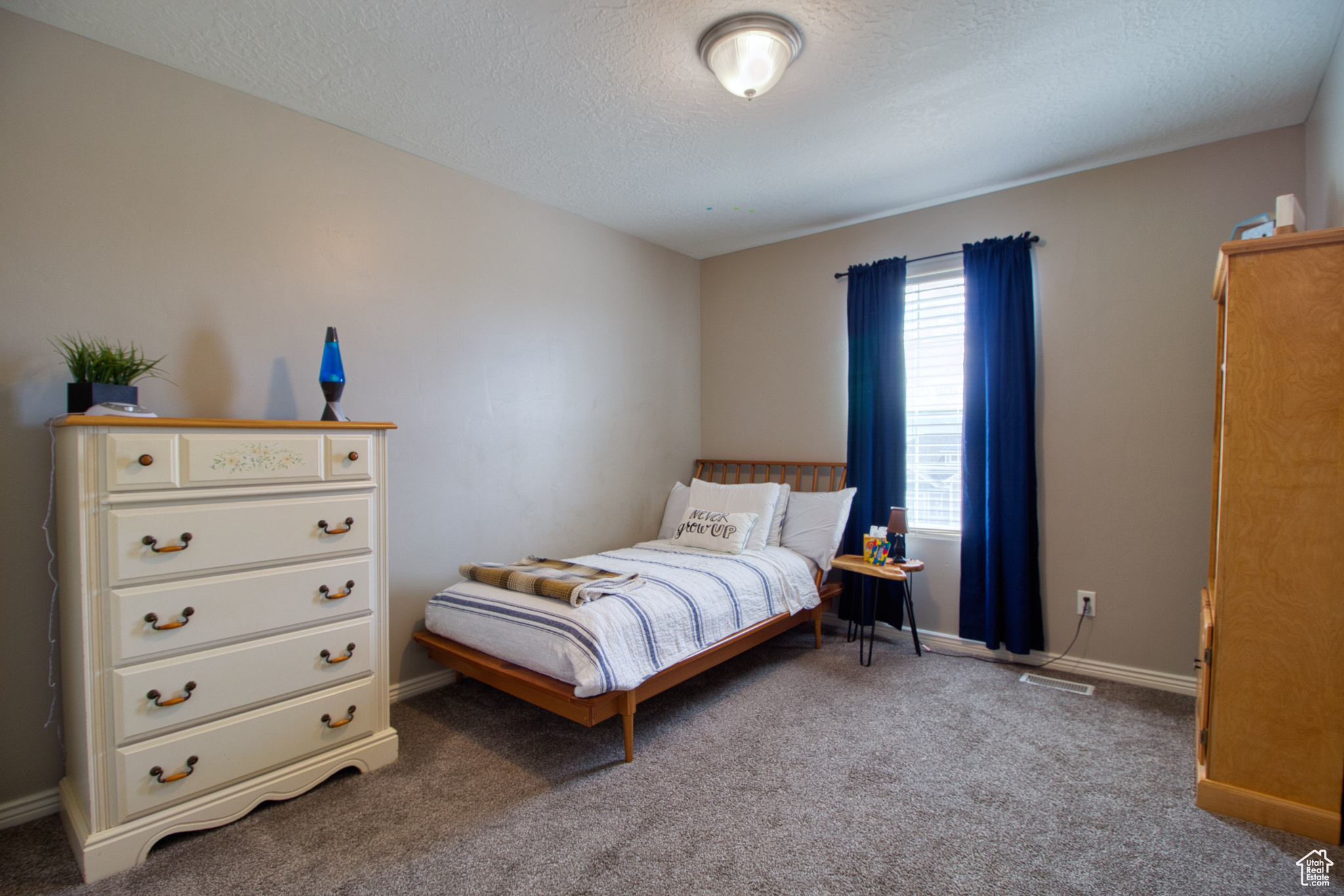 Carpeted bedroom featuring a textured ceiling