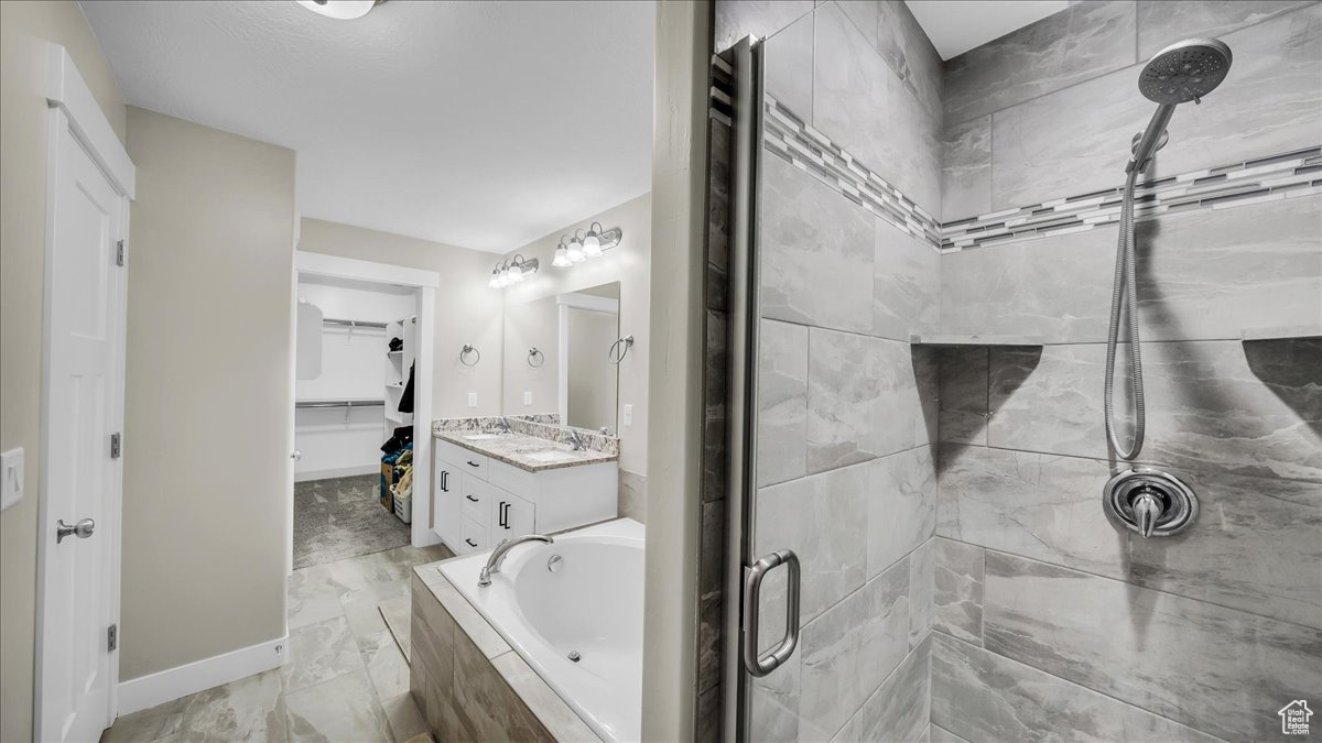 Main bathroom featuring plus walk in shower and vanity