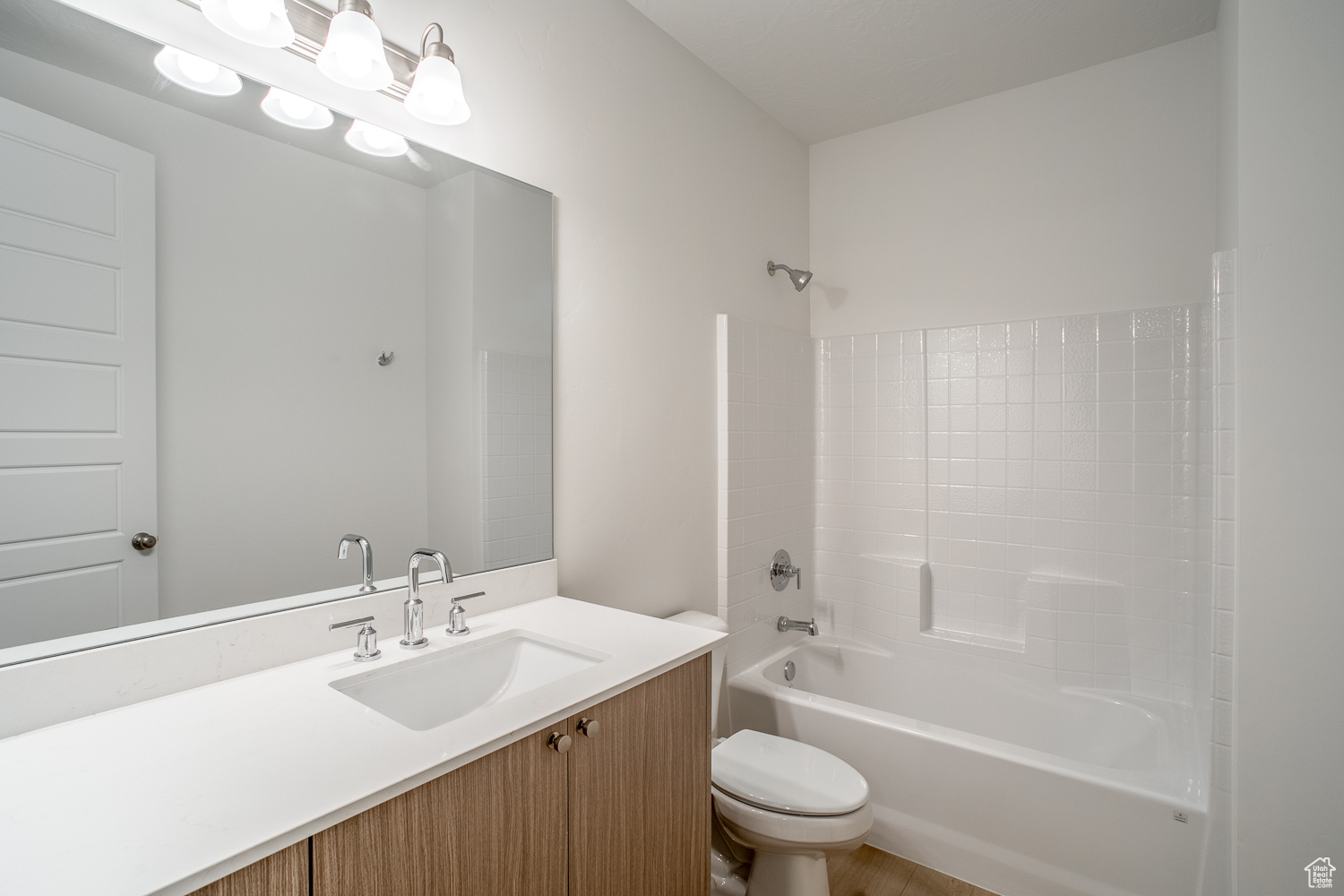 Full bathroom featuring vanity, toilet, and shower / washtub combination