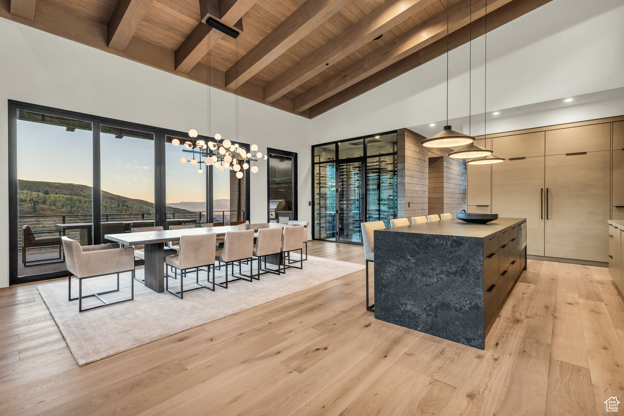 Kitchen featuring hanging light fixtures, high vaulted ceiling, and a spacious island