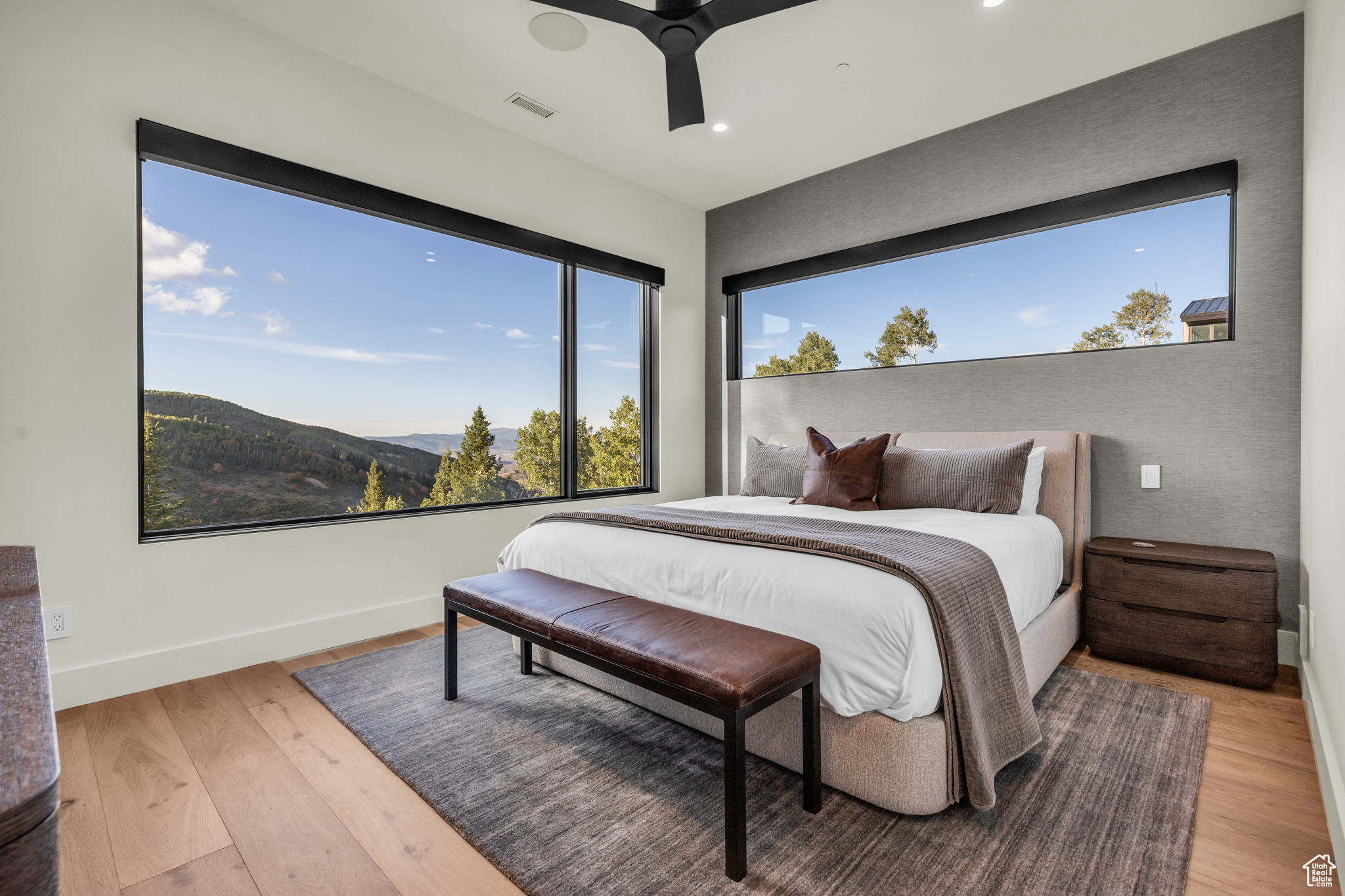 Bedroom featuring a mountain view, light hardwood / wood-style flooring, and ceiling fan