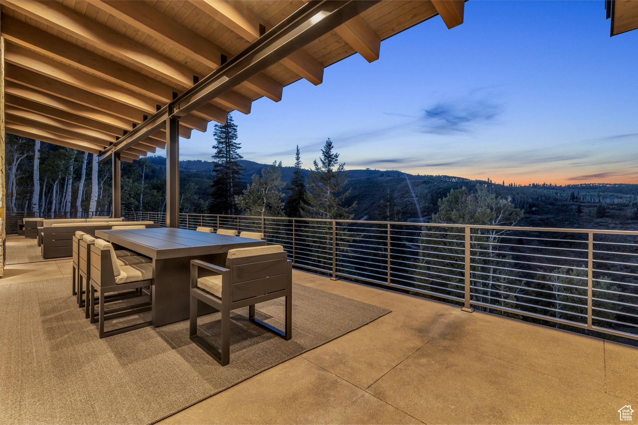 Patio terrace at dusk featuring a mountain view