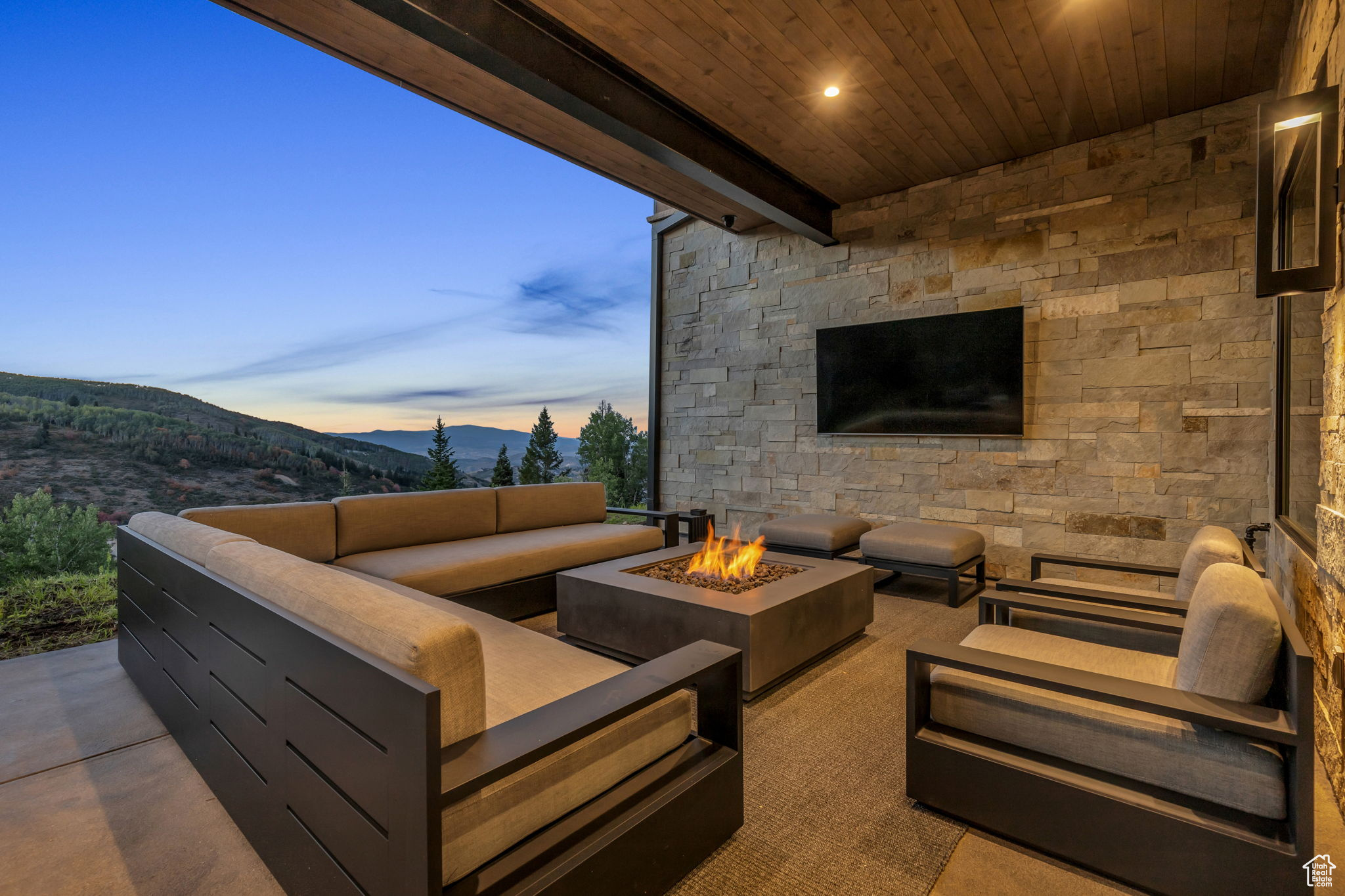 View of patio with an outdoor living space with a fire pit