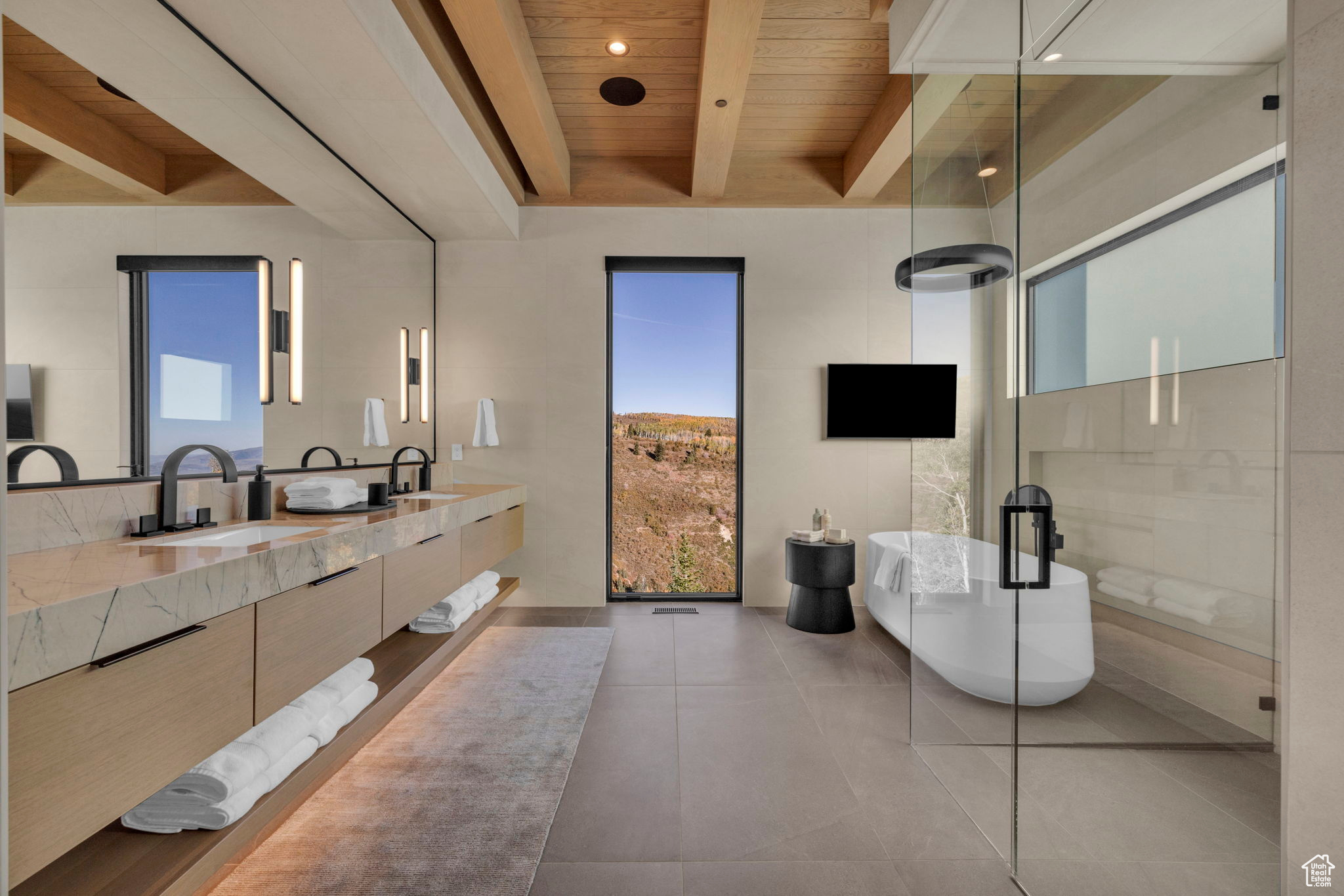 Bathroom featuring a wealth of natural light, a bathtub, vanity, and wood ceiling