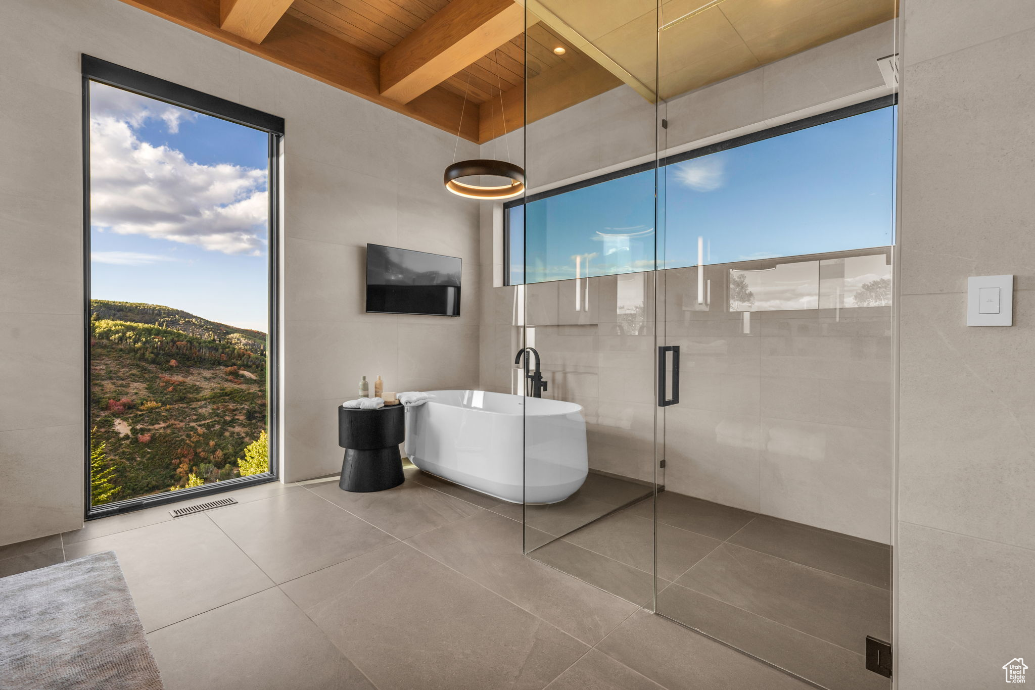 Bathroom featuring plus walk in shower, a healthy amount of sunlight, wooden ceiling, and beam ceiling